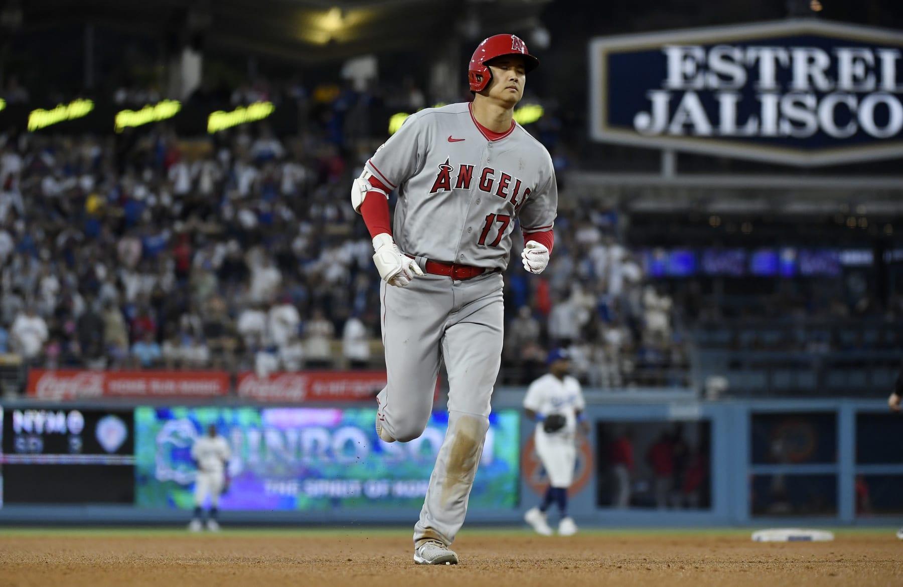 LOS ANGELES, CALIFORNIA - JULY 8: Shohei Ohtani #17 of the Los Angeles Angels runs the bases after hitting a two run homer un to score Andrew Velazquez #4 against pitcher pitcher Michael Grove #78 of the Los Angeles Dodgers during the seventh inning at Dodger Stadium on July 8, 2023 in Los Angeles, California. (Photo by Kevork Djansezian/Getty Images)
