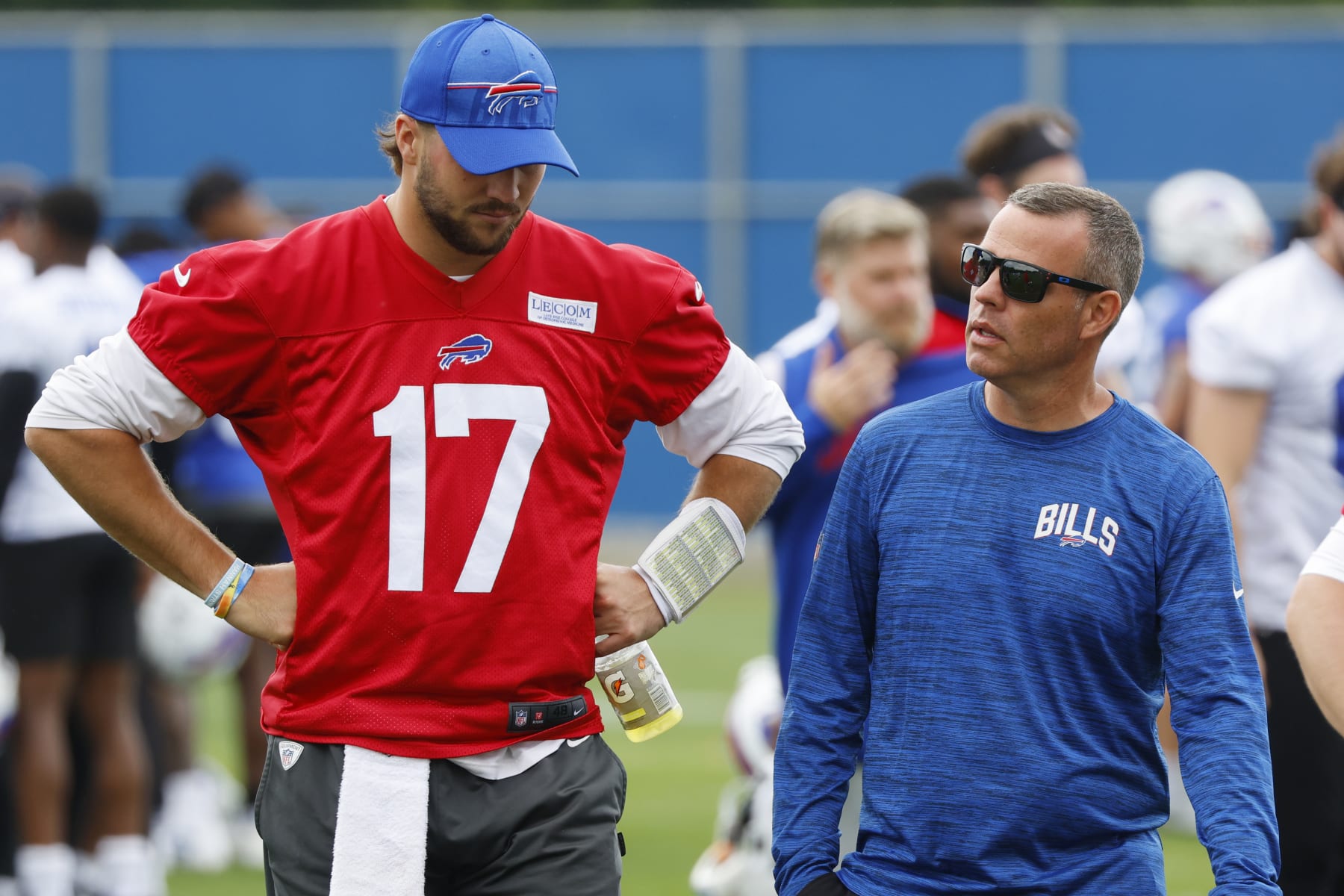 Buffalo Bills quarterback Josh Allen (17) and General Manager Brandon Beane talk following NFL football practice in Orchard Park, N.Y., Tuesday June 13, 2023. (AP Photo/Jeffrey T. Barnes)