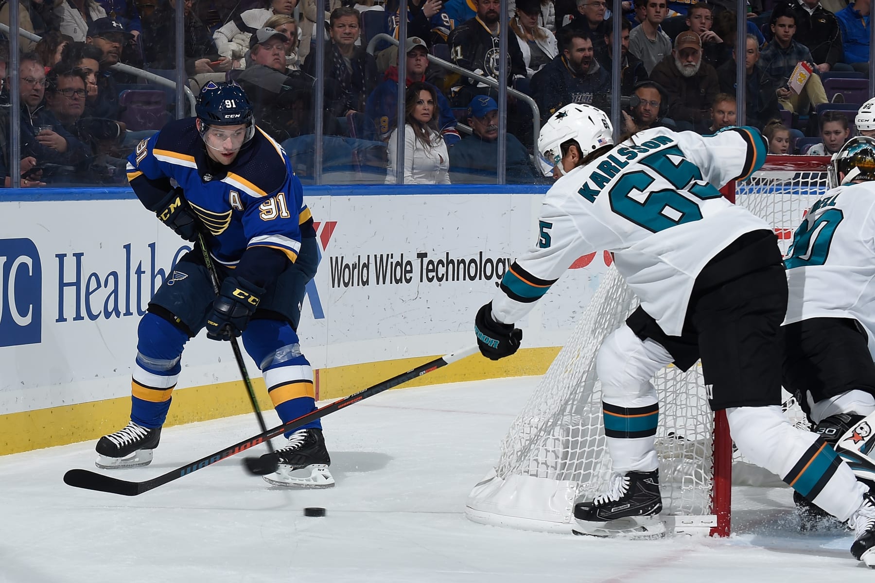 ST. LOUIS, MO - NOVEMBER 9: Erik Karlsson #65 of the San Jose Sharks defends against Vladimir Tarasenko #91 of the St. Louis Blues at Enterprise Center on November 9, 2018 in St. Louis, Missouri. (Photo by Joe Puetz/NHLI via Getty Images) 