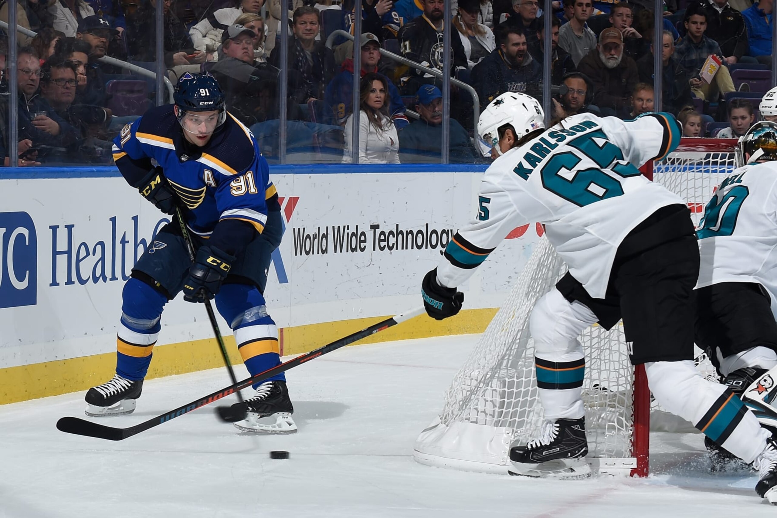ST. LOUIS, MO - NOVEMBER 9: Erik Karlsson #65 of the San Jose Sharks defends against Vladimir Tarasenko #91 of the St. Louis Blues at Enterprise Center on November 9, 2018 in St. Louis, Missouri. (Photo by Joe Puetz/NHLI via Getty Images) 