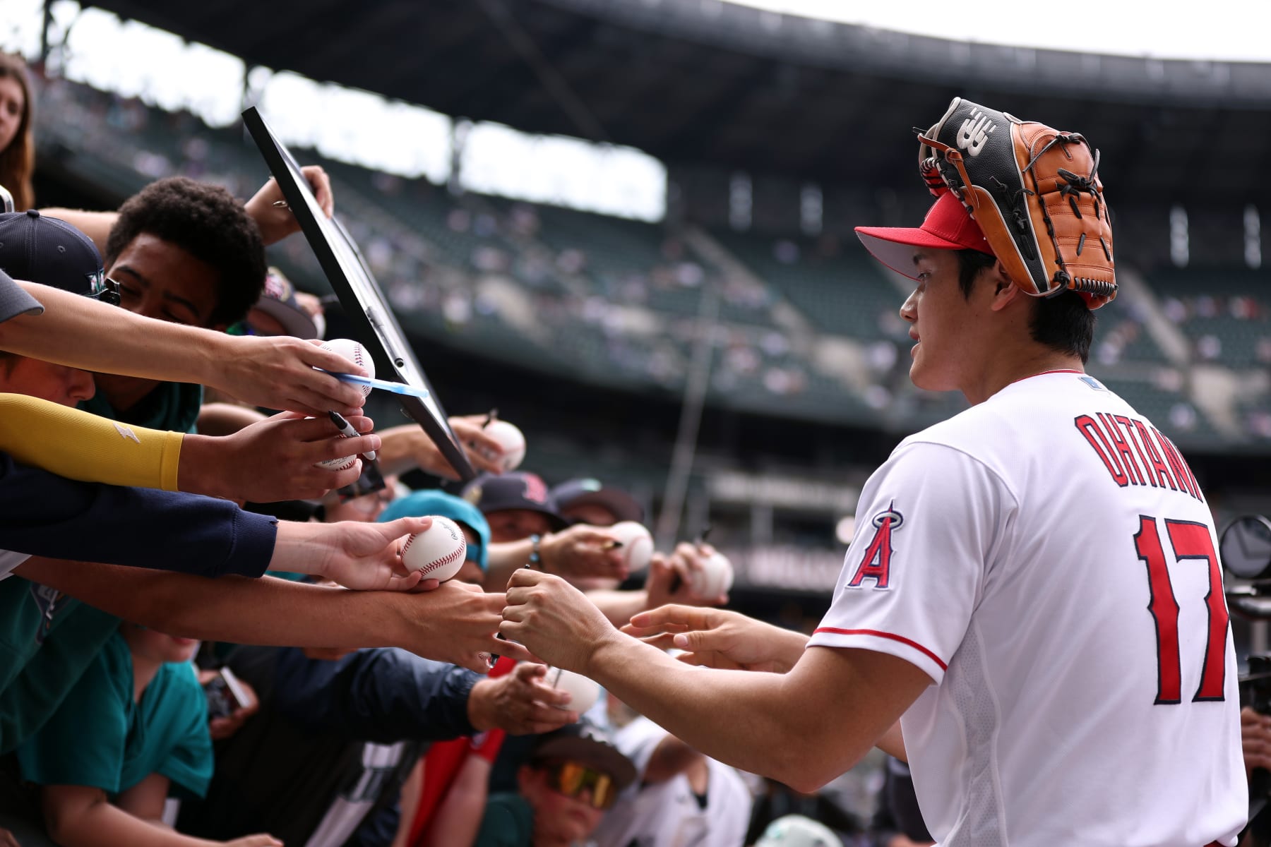 SEATTLE, WASHINGTON - JULY 10: Shohei Ohtani #17 of the Los Angeles Angels signs autographs during Gatorade All-Star Workout Day at T-Mobile Park on July 10, 2023 in Seattle, Washington. (Photo by Steph Chambers/Getty Images)