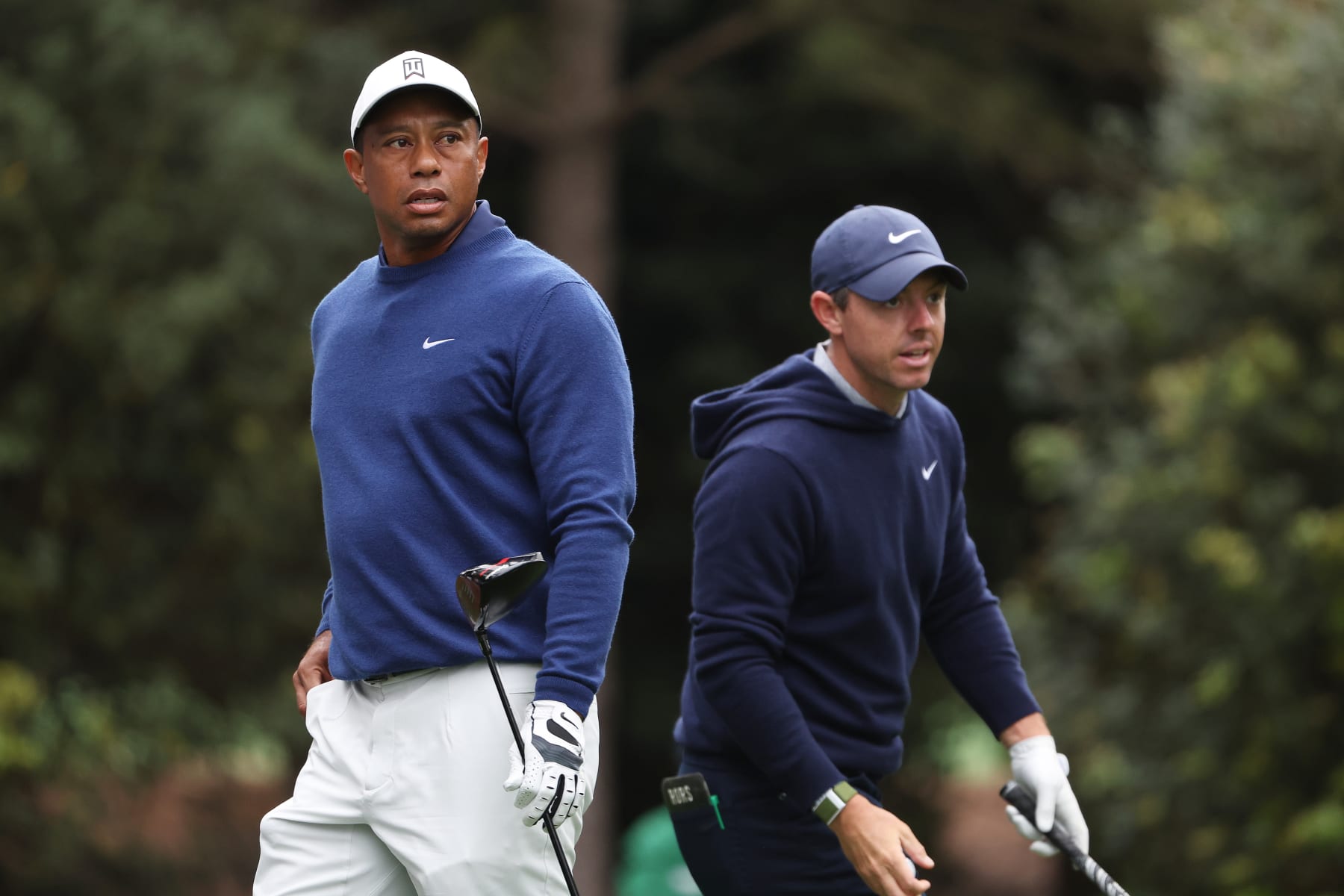 AUGUSTA, GEORGIA - APRIL 03: Tiger Woods of the United States and Rory McIlroy of Northern Ireland look on from the 11th tee during a practice round prior to the 2023 Masters Tournament at Augusta National Golf Club on April 03, 2023 in Augusta, Georgia. (Photo by Christian Petersen/Getty Images)