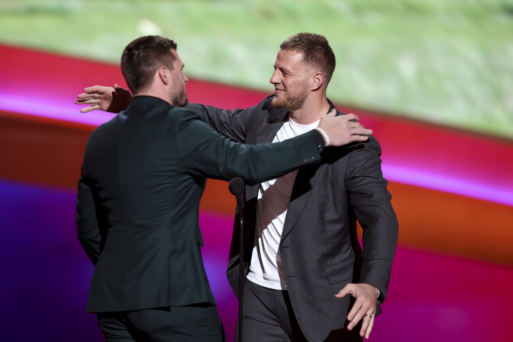 INGLEWOOD, CALIFORNIA - FEBRUARY 10: T.J. Watt (L) hugs his brother, J.J. Watt as T.J. receives the AP Defensive Player of the Year Award during the NFL Honors show at the YouTube Theater on February 10, 2022 in Inglewood, California. (Photo by Michael Owens/Getty Images)