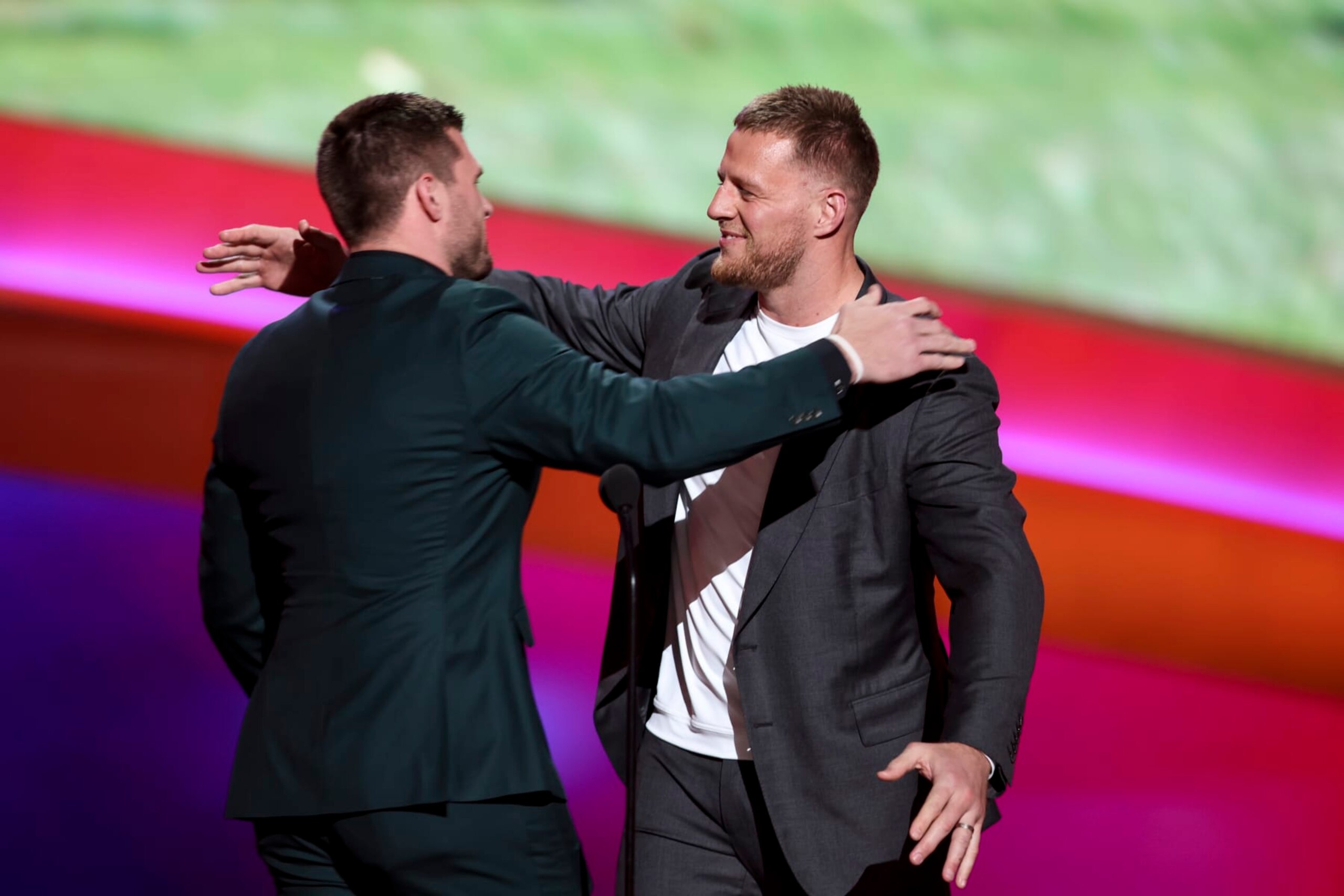 INGLEWOOD, CALIFORNIA - FEBRUARY 10: T.J. Watt (L) hugs his brother, J.J. Watt as T.J. receives the AP Defensive Player of the Year Award during the NFL Honors show at the YouTube Theater on February 10, 2022 in Inglewood, California. (Photo by Michael Owens/Getty Images)
