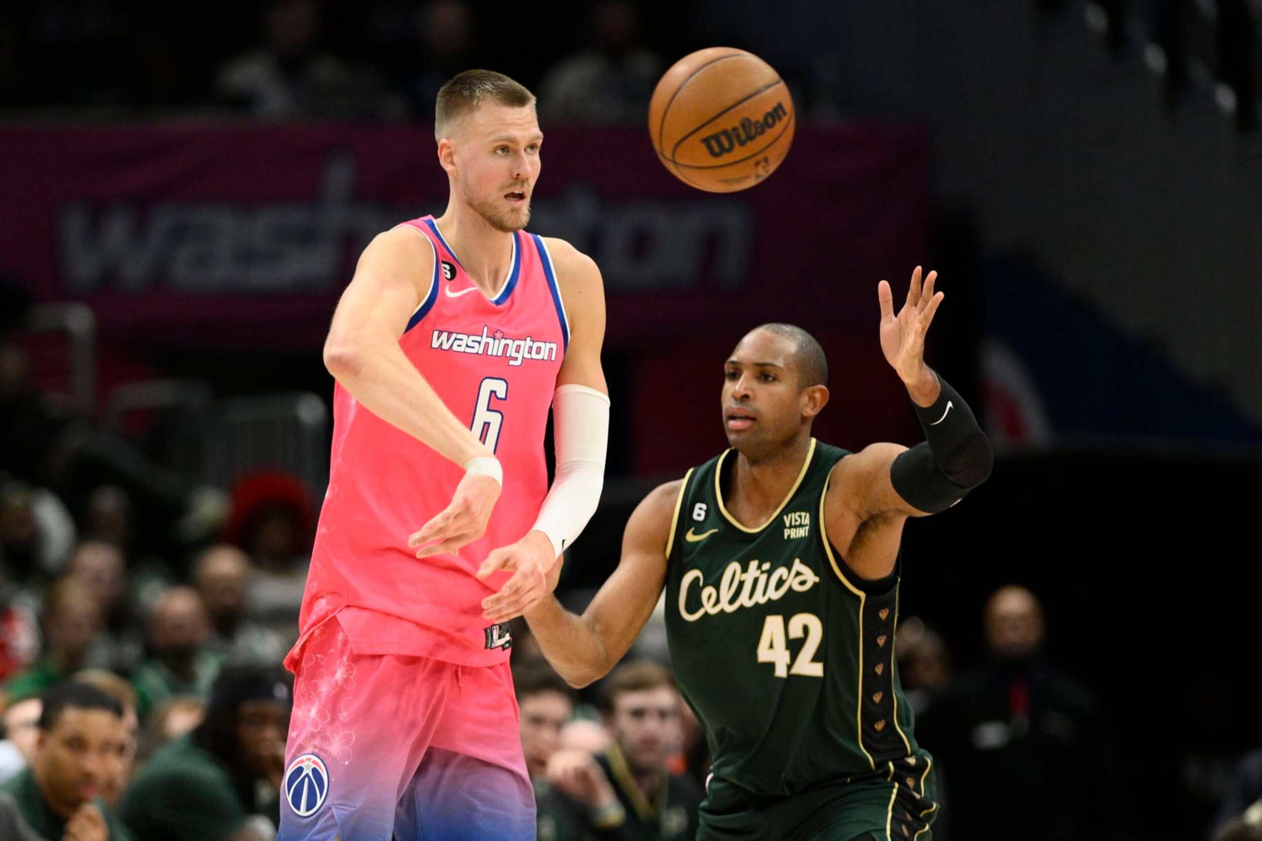 Washington Wizards center Kristaps Porzingis (6) passes the ball against Boston Celtics center Al Horford (42) during the second half of an NBA basketball game, Tuesday, March 28, 2023, in Washington. The Wizards won 130-111. (AP Photo/Nick Wass) Washington Wizards center Kristaps Porzingis (6) passes the ball against Boston Celtics center Al Horford (42) during the second half of an NBA basketball game, Tuesday, March 28, 2023, in Washington. The Wizards won 130-111. (AP Photo/Nick Wass)