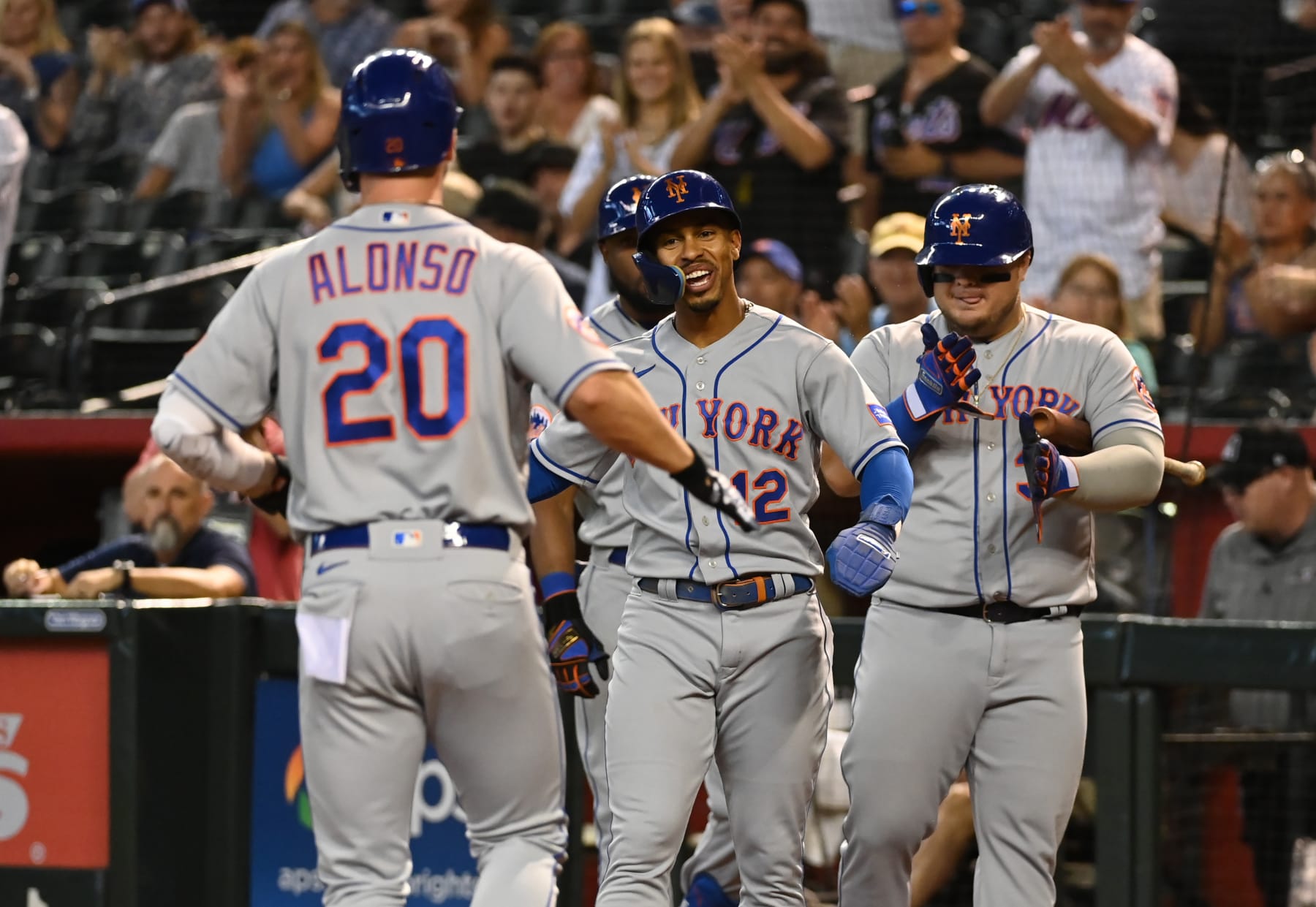 PHOENIX, ARIZONA - JULY 06: Pete Alfonso #20 of the New York Mets celebrates with Francisco Lindor #12 and Daniel Vogelbach #32 after hitting a two run home run against the Arizona Diamondbacks during the first inning at Chase Field on July 06, 2023 in Phoenix, Arizona. (Photo by Norm Hall/Getty Images)