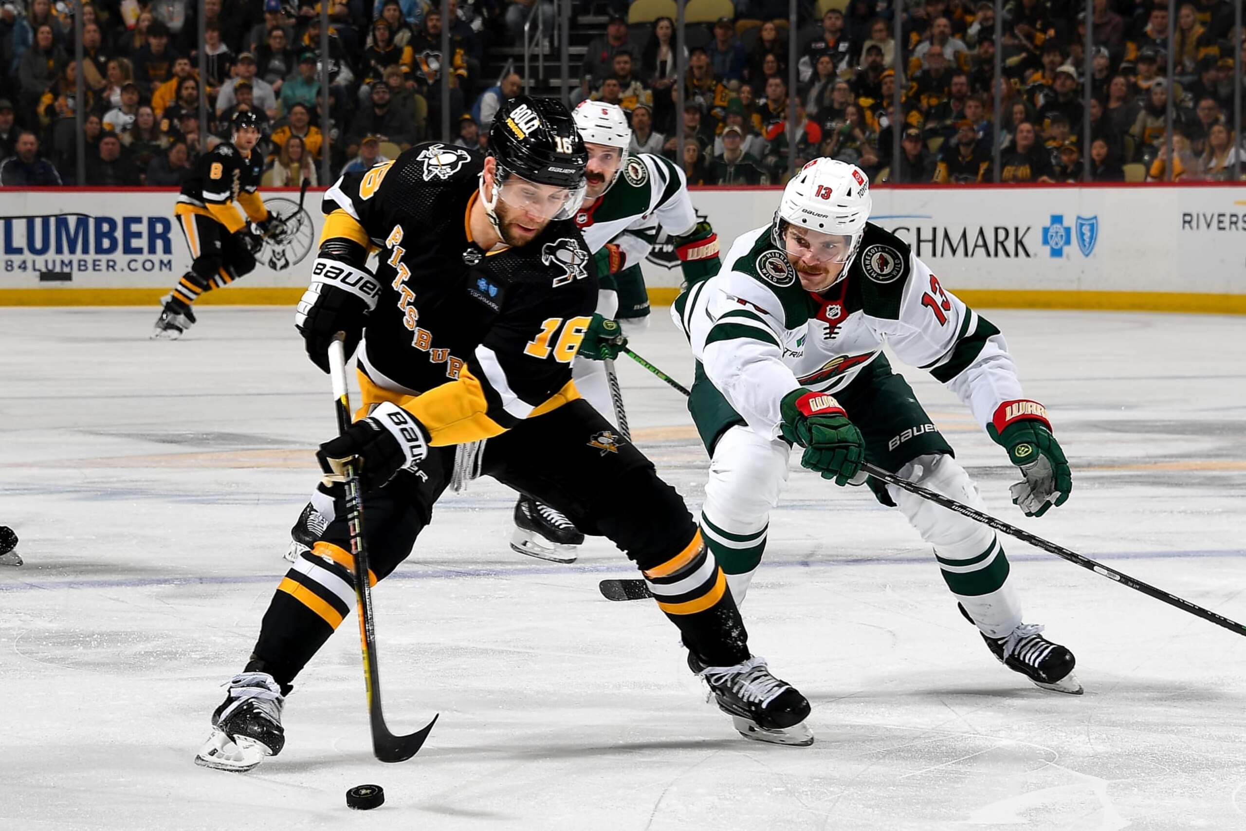 PITTSBURGH, PA - APRIL 06:  Jason Zucker #16 of the Pittsburgh Penguins skate against Sam Steel #13 of the Minnesota Wild at PPG PAINTS Arena on April 6, 2023 in Pittsburgh, Pennsylvania. (Photo by Joe Sargent/NHLI via Getty Images)