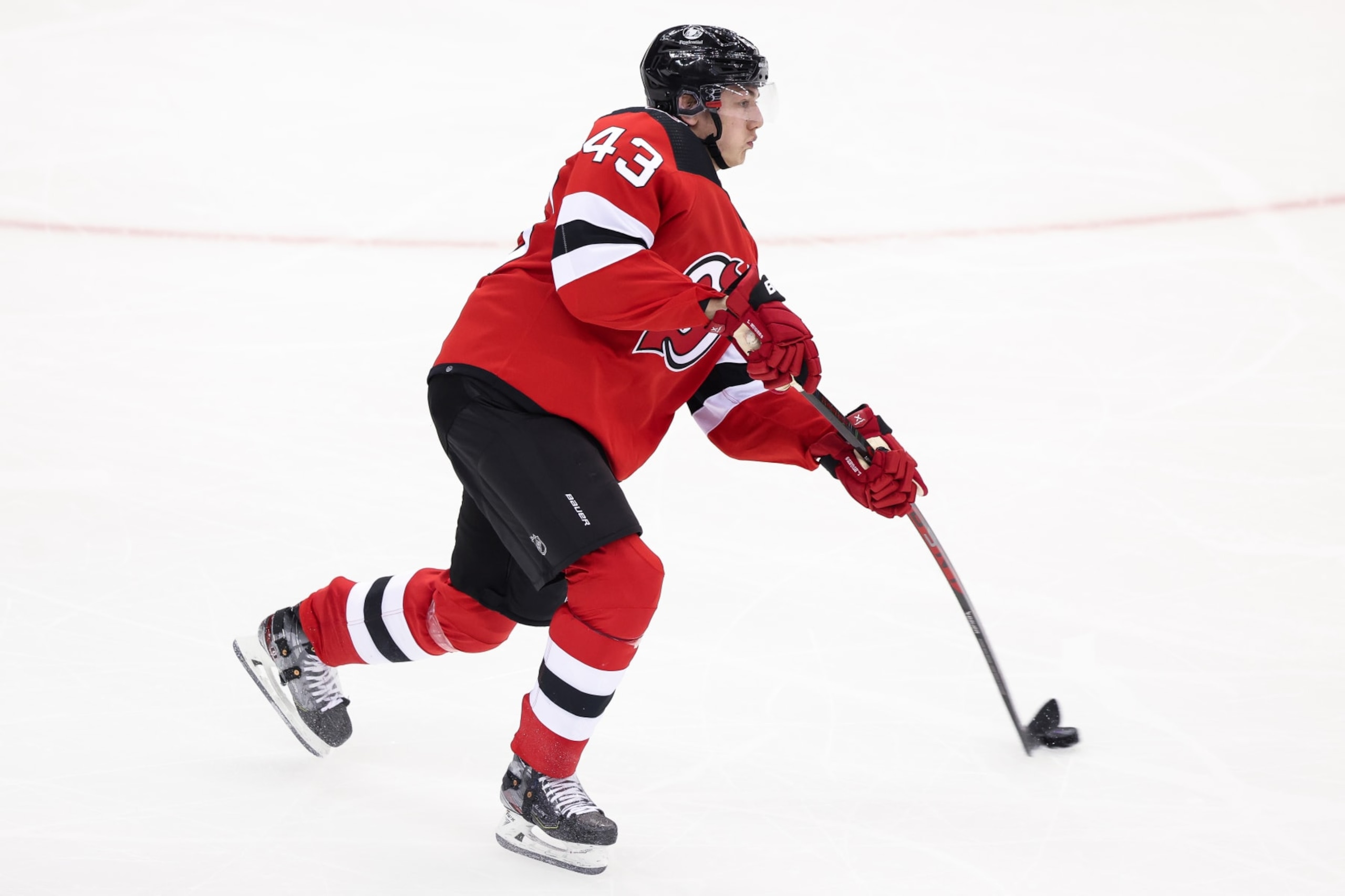 NEWARK, NJ - MAY 09: New Jersey Devils defenseman Luke Hughes (43) skates with the puck during Game 4 of an Eastern Conference Second Round playoff game between the Carolina Hurricanes and the New Jersey Devils on May 9, 2023, at Prudential Center in Newark, New Jersey. (Photo by Andrew Mordzynski/Icon Sportswire via Getty Images)