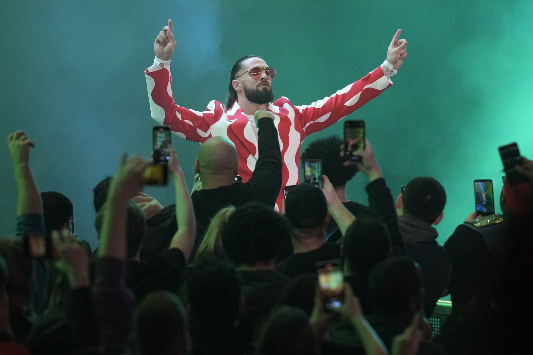 Fans cheer on wrestler Seth "Freakin" Rollins during the WWE Monday Night RAW event, Monday, March 6, 2023, in Boston. (AP Photo/Charles Krupa)