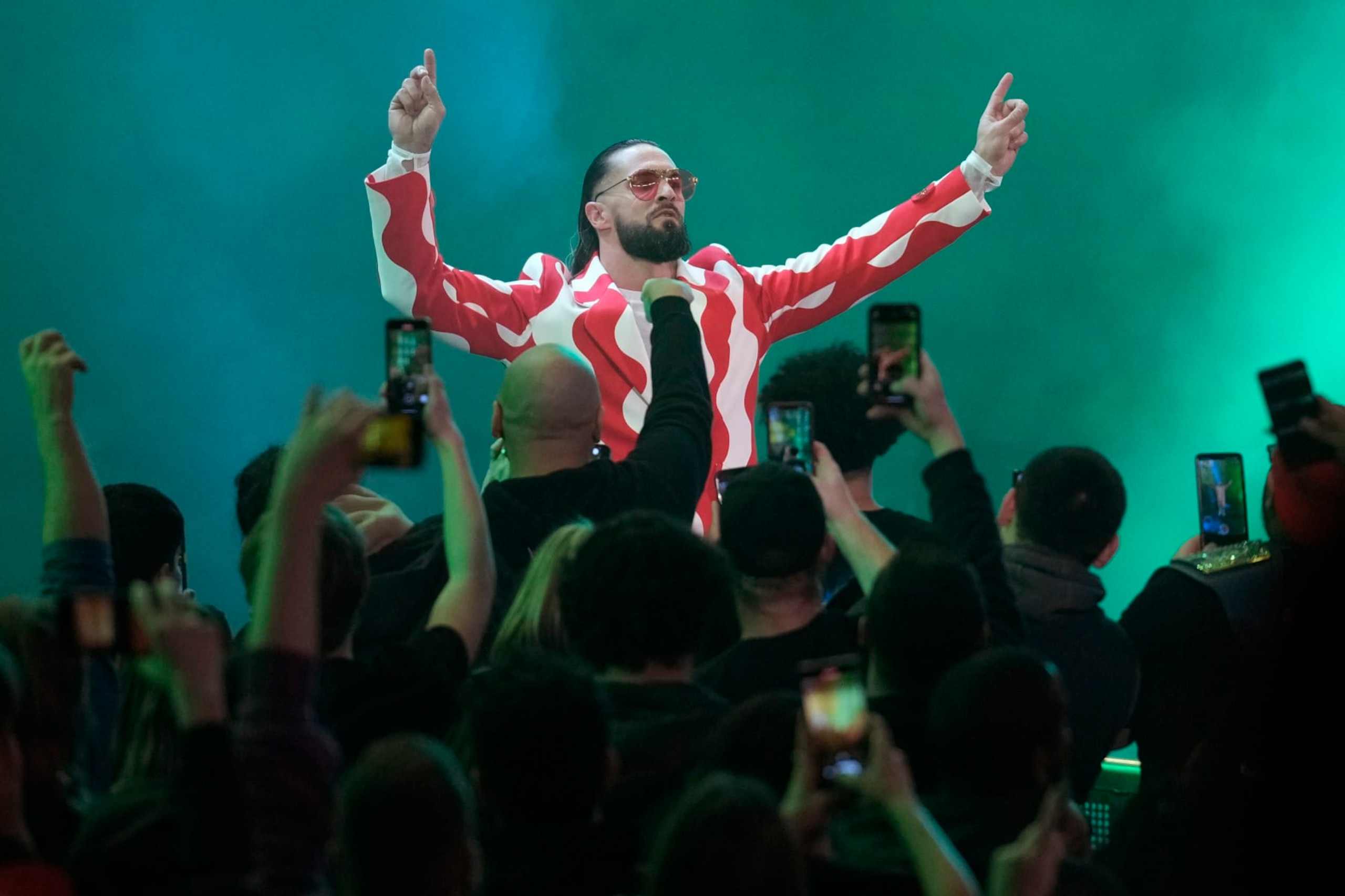 Fans cheer on wrestler Seth "Freakin" Rollins during the WWE Monday Night RAW event, Monday, March 6, 2023, in Boston. (AP Photo/Charles Krupa) Fans cheer on wrestler Seth "Freakin" Rollins during the WWE Monday Night RAW event, Monday, March 6, 2023, in Boston. (AP Photo/Charles Krupa)