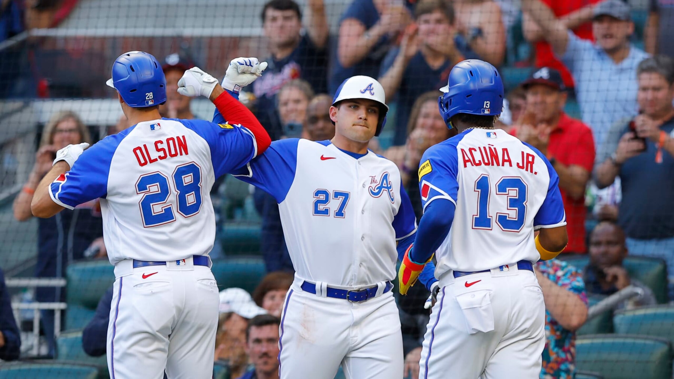 ATLANTA, GA - MAY 20: Austin Riley #27 celebrates as Matt Olson #28 and Ronald Acuna Jr. #13 of the Atlanta Braves crosses the plate following Olsons two run home run during the first inning against the Seattle Mariners at Truist Park on May 20, 2023 in Atlanta, Georgia. (Photo by Todd Kirkland/Getty Images)