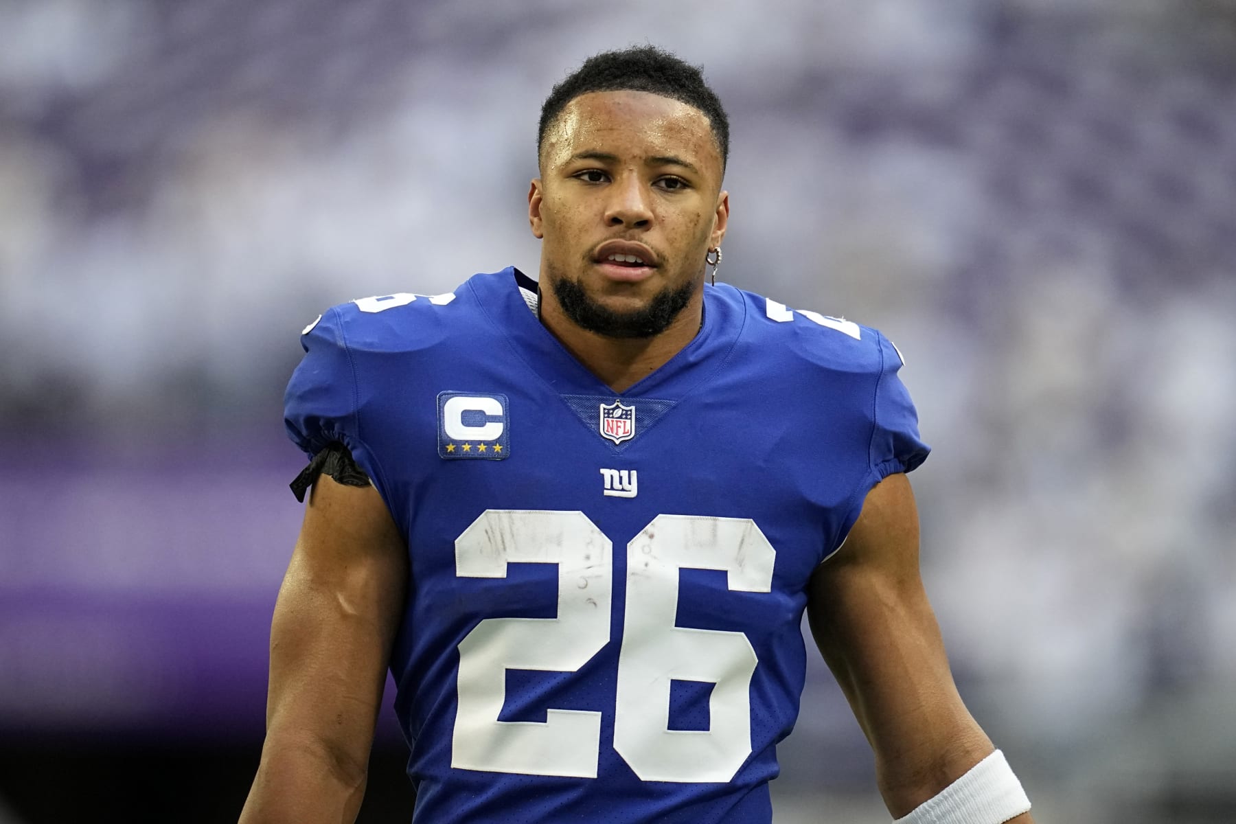 New York Giants running back Saquon Barkley walks on the field before an NFL football game against the Minnesota Vikings, Saturday, Dec. 24, 2022, in Minneapolis. (AP Photo/Abbie Parr)