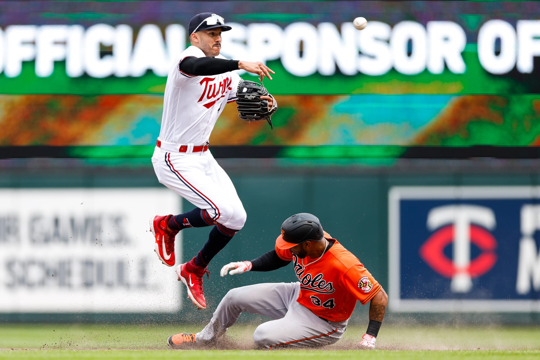 MINNEAPOLIS, MINNESOTA - JULY 8: Aaron Hicks #34 of the Baltimore Orioles is out at second base as Carlos Correa #4 of the Minnesota Twins throws the ball to first base on a fielder's choice in the sixth inning at Target Field on July 8, 2023 in Minneapolis, Minnesota. The Orioles defeated the Twins 6-2. (Photo by David Berding/Getty Images)