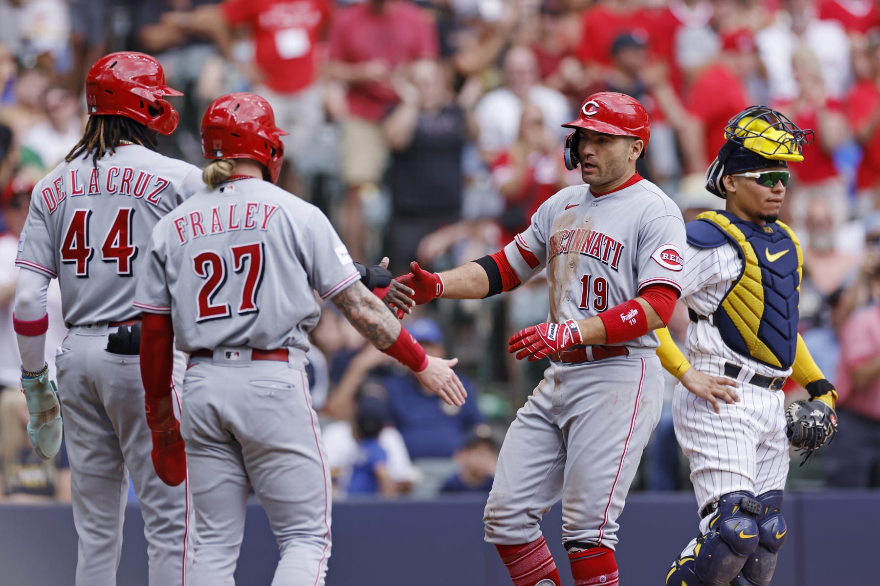 MILWAUKEE, WI - JULY 08: Cincinnati Reds first baseman Joey Votto (19) celebrates with right fielder Jake Fraley (27) and shortstop Elly De La Cruz (44) after hitting a three-run home run to tie the game in the fourth inning of an MLB game against the Milwaukee Brewers on July 8, 2023 at American Family Field in Milwaukee, Wisconsin. (Photo by Joe Robbins/Icon Sportswire via Getty Images)