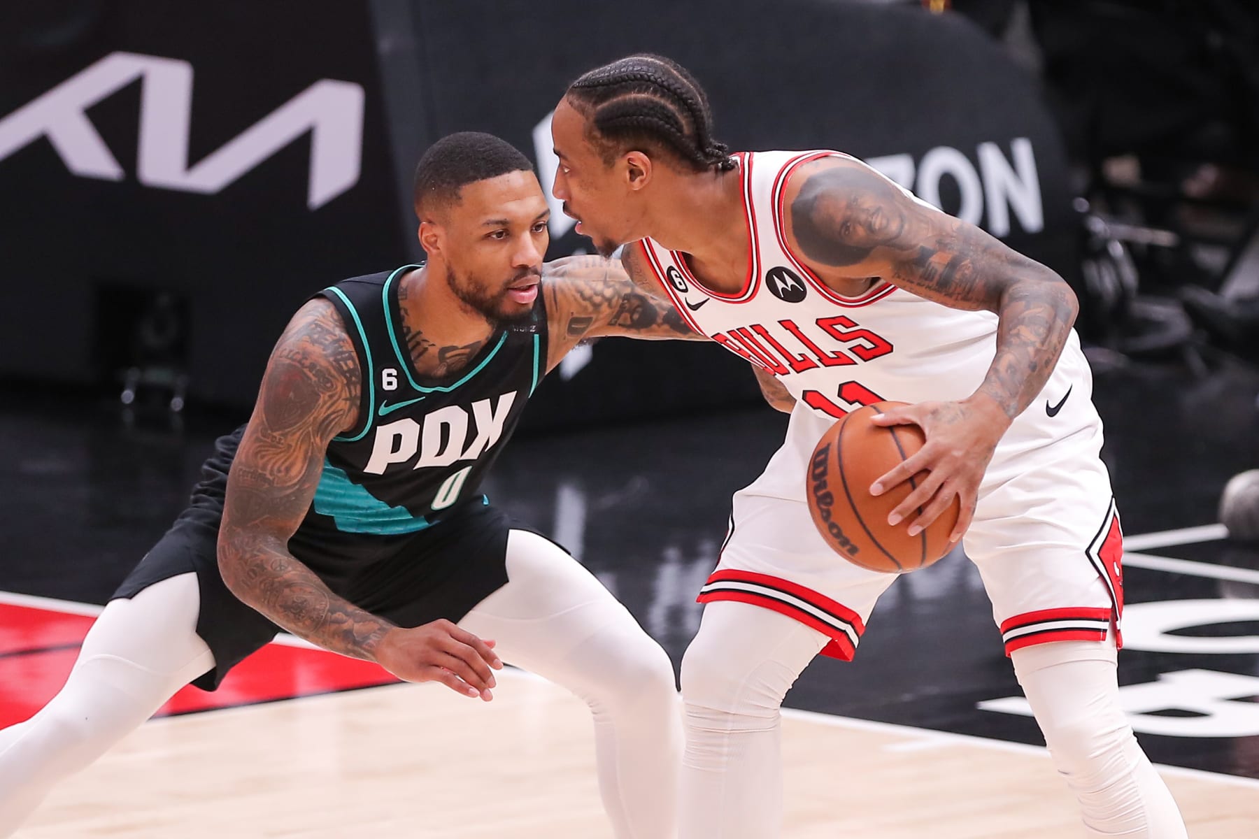 CHICAGO, IL - FEBRUARY 04: Portland Trail Blazers Guard Damian Lillard (0) posts up against Chicago Bulls Forward DeMar DeRozan (11) during a NBA game between the Portland Trail Blazers and the Chicago Bulls on February 4, 2023 at the United Center in Chicago, IL. (Photo by Melissa Tamez/Icon Sportswire via Getty Images)