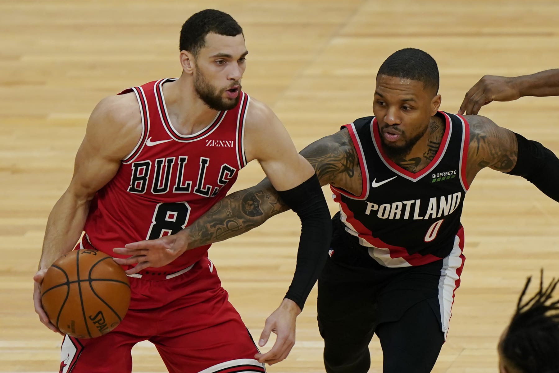 Chicago Bulls guard Zach LaVine, left, looks to pass as Portland Trail Blazers guard Damian Lillard tries to steal the ball during the first half of an NBA basketball game in Chicago, Saturday, Jan. 30, 2021. (AP Photo/Nam Y. Huh)