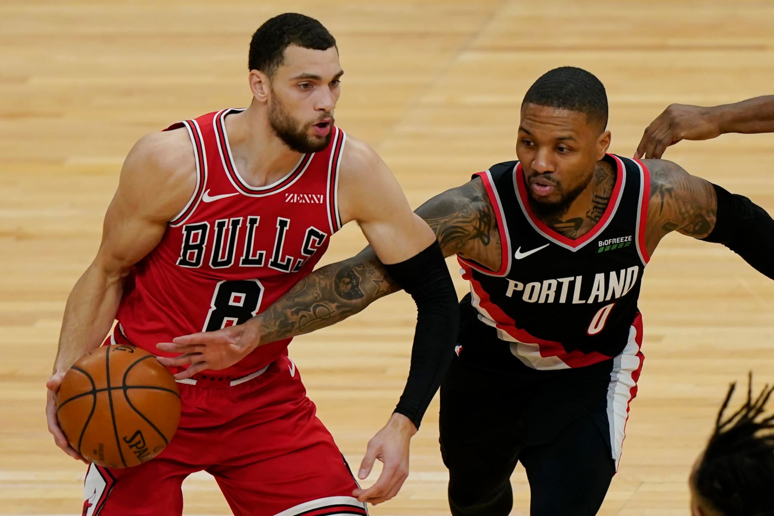 Chicago Bulls guard Zach LaVine, left, looks to pass as Portland Trail Blazers guard Damian Lillard tries to steal the ball during the first half of an NBA basketball game in Chicago, Saturday, Jan. 30, 2021. (AP Photo/Nam Y. Huh)