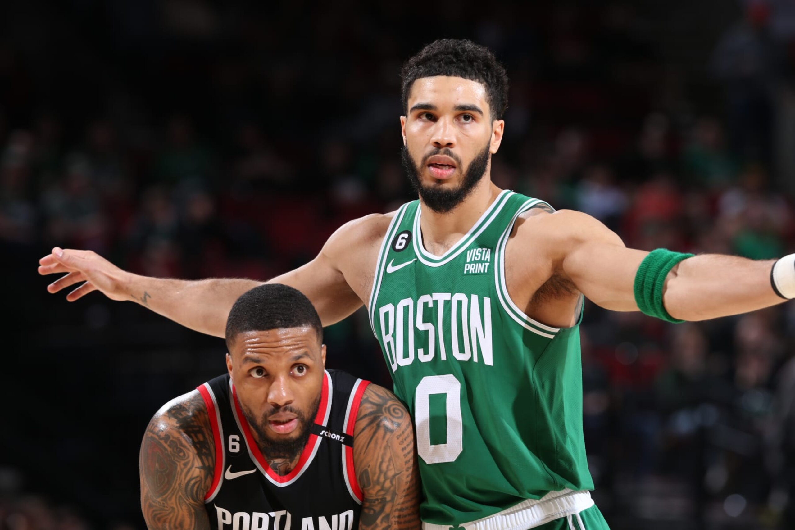 PORTLAND, OR - MARCH 17:  Damian Lillard #0 of the Portland Trail Blazers and Jayson Tatum #0 of the Boston Celtics looks on during the game on March 17, 2023 at the Moda Center Arena in Portland, Oregon. NOTE TO USER: User expressly acknowledges and agrees that, by downloading and or using this photograph, user is consenting to the terms and conditions of the Getty Images License Agreement. Mandatory Copyright Notice: Copyright 2023 NBAE (Photo by Sam Forencich/NBAE via Getty Images)
