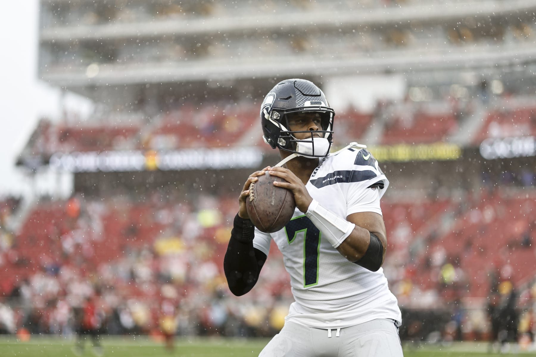 SANTA CLARA, CALIFORNIA - JANUARY 14: Geno Smith #7 of the Seattle Seahawks passes as he warms up prior to an NFL football game between the San Francisco 49ers and the Seattle Seahawks at Levi's Stadium on January 14, 2023 in Santa Clara, California. (Photo by Michael Owens/Getty Images)