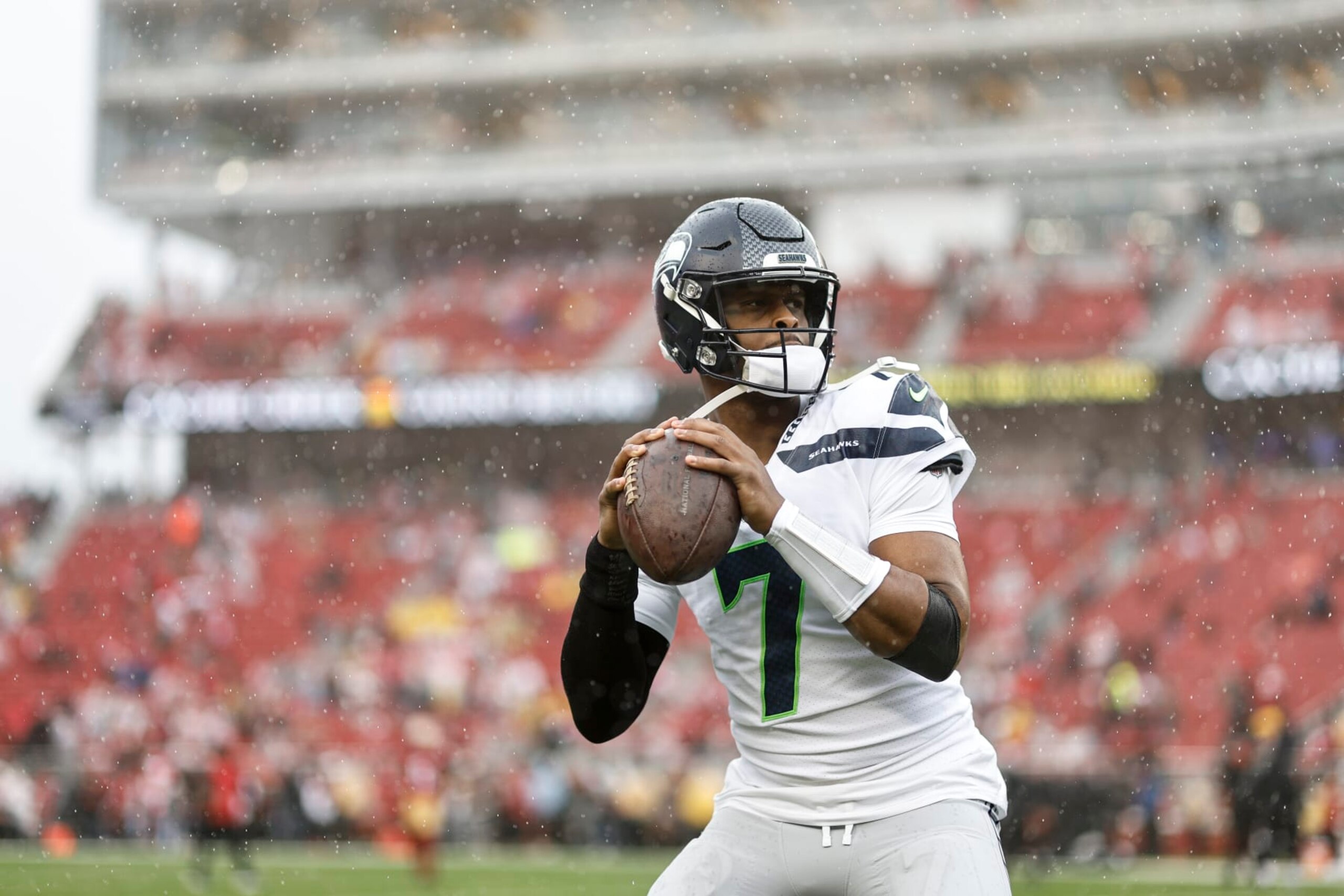 SANTA CLARA, CALIFORNIA - JANUARY 14: Geno Smith #7 of the Seattle Seahawks passes as he warms up prior to an NFL football game between the San Francisco 49ers and the Seattle Seahawks at Levi's Stadium on January 14, 2023 in Santa Clara, California. (Photo by Michael Owens/Getty Images)