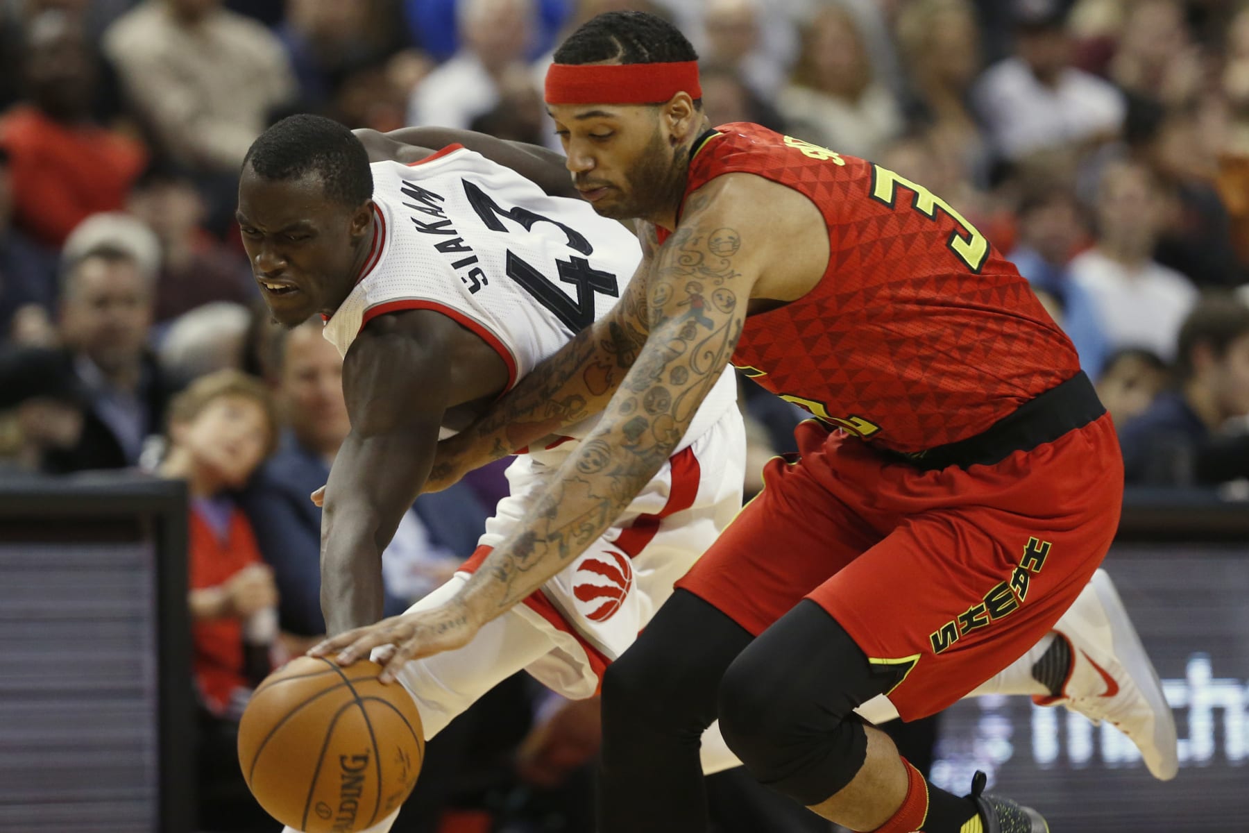 TORONTO, ON - DECEMBER 3: Toronto Raptors forward Pascal Siakam (43) looks to recover the loose ball from Atlanta Hawks forward Mike Scott (32). Toronto Raptors vs Atlanta Hawks in 2nd half action of NBA regular season play at Air Canada Centre. Raps win 128 - 84. Toronto Star/Rick Madonik        (Rick Madonik/Toronto Star via Getty Images)
