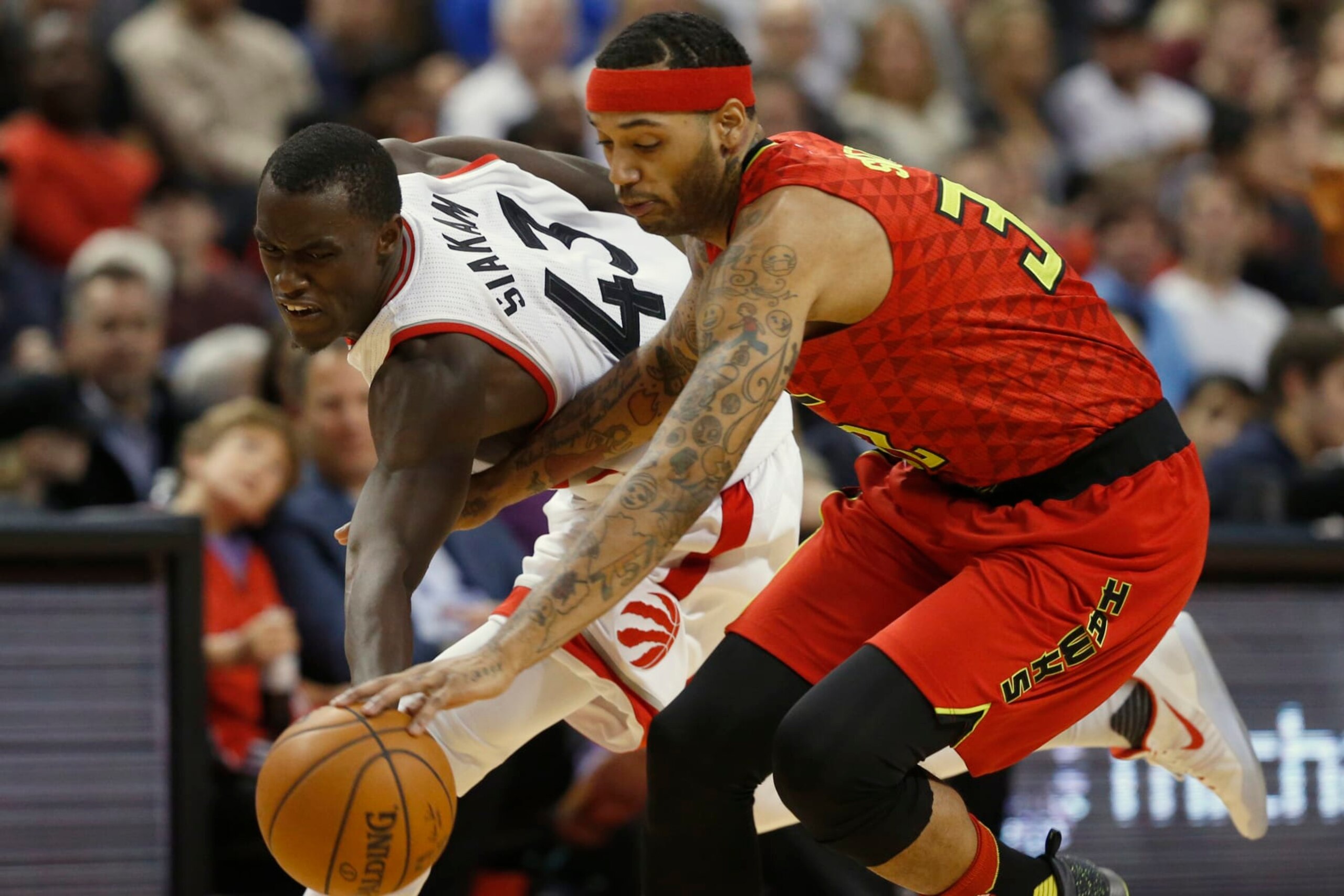 TORONTO, ON - DECEMBER 3: Toronto Raptors forward Pascal Siakam (43) looks to recover the loose ball from Atlanta Hawks forward Mike Scott (32). Toronto Raptors vs Atlanta Hawks in 2nd half action of NBA regular season play at Air Canada Centre. Raps win 128 - 84. Toronto Star/Rick Madonik        (Rick Madonik/Toronto Star via Getty Images)