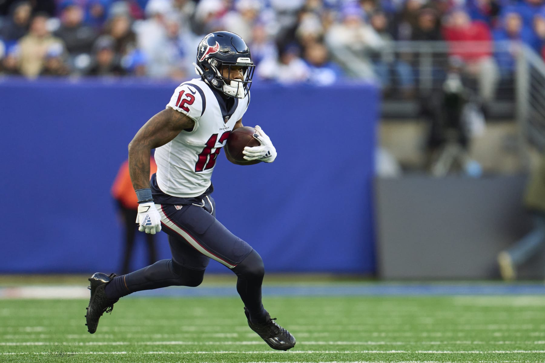 EAST RUTHERFORD, NJ - NOVEMBER 13: Nico Collins #12 of the Houston Texans runs with the ball against the New York Giants during the second half at MetLife Stadium on November 13, 2022 in East Rutherford, New Jersey. (Photo by Cooper Neill/Getty Images)