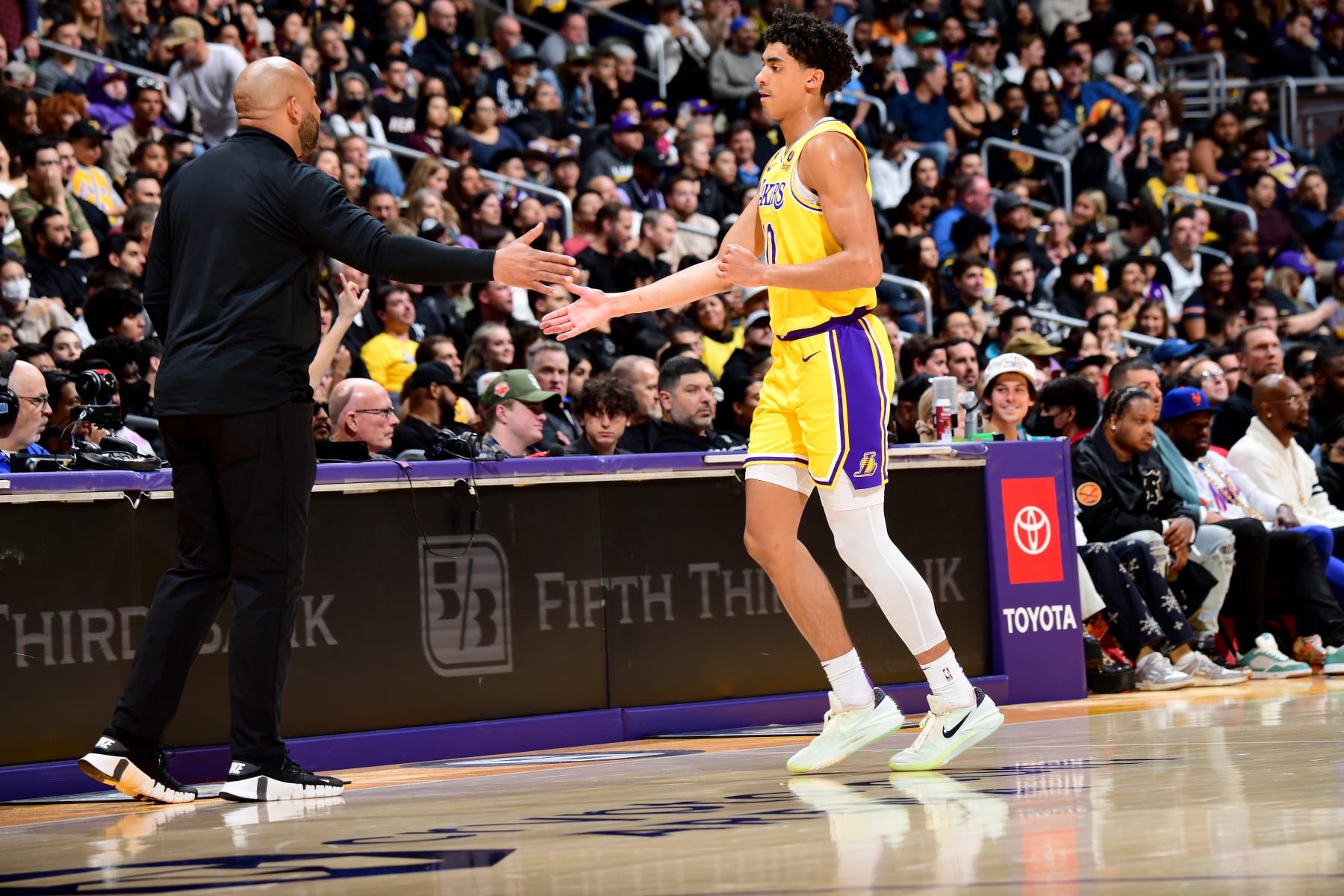 LOS ANGELES, CA - JANUARY 25: Max Christie #10 and Head Coach Darvin Ham of the Los Angeles Lakers high fives during the game against the San Antonio Spurs on January 25, 2023 at Crypto.Com Arena in Los Angeles, California. NOTE TO USER: User expressly acknowledges and agrees that, by downloading and/or using this Photograph, user is consenting to the terms and conditions of the Getty Images License Agreement. Mandatory Copyright Notice: Copyright 2023 NBAE (Photo by Adam Pantozzi/NBAE via Getty Images)