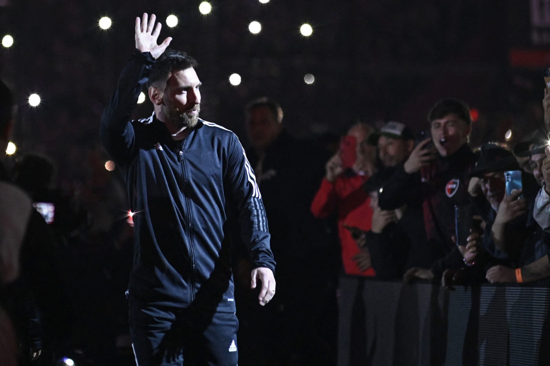 Argentine football player Lionel Messi greets fans during his entrance to the field before the start of Maximiliano Rodriguez's farewell match at the Marcelo Bielsa stadium in Rosario, Argentina on January 24, 2023. (Photo by STRINGER / AFP) (Photo by STRINGER/AFP via Getty Images)