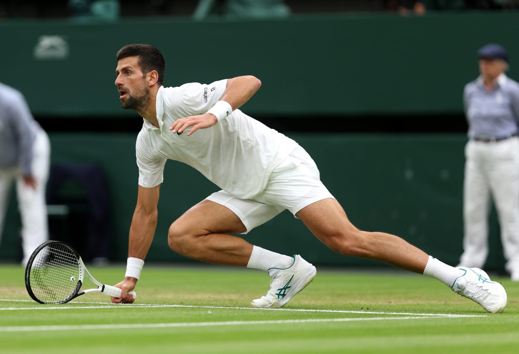 LONDON, ENGLAND - JULY 14: Novak Djokovic of Serbia prepares to play a shot against Jannik Sinner of Italy in the Men's Singles Semi Finals on day twelve of The Championships Wimbledon 2023 at All England Lawn Tennis and Croquet Club on July 14, 2023 in London, England. (Photo by Julian Finney/Getty Images)