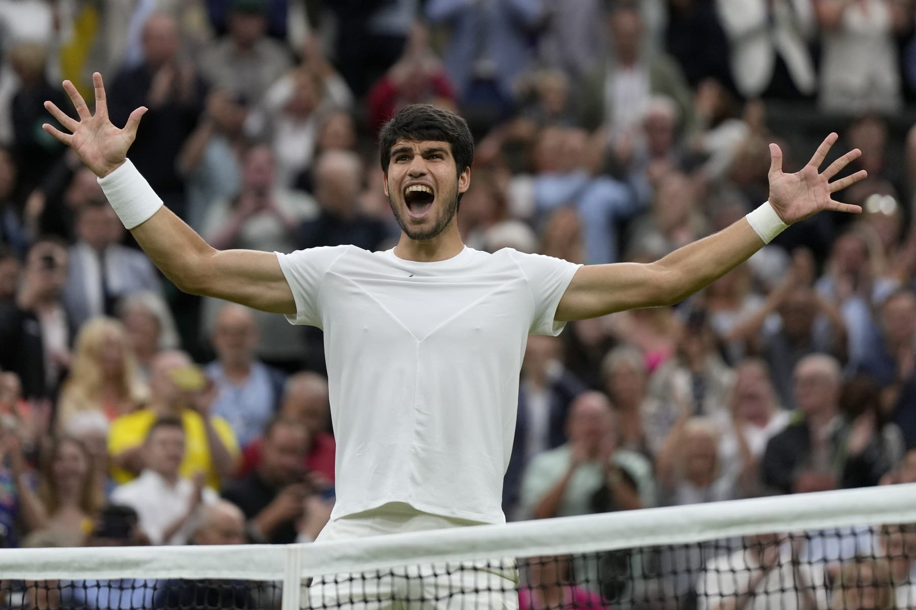 Spain's Carlos Alcaraz celebrates after beating Russia's Daniil Medvedev to win their men's singles semifinal match on day twelve of the Wimbledon tennis championships in London, Friday, July 14, 2023. (AP Photo/Alastair Grant)