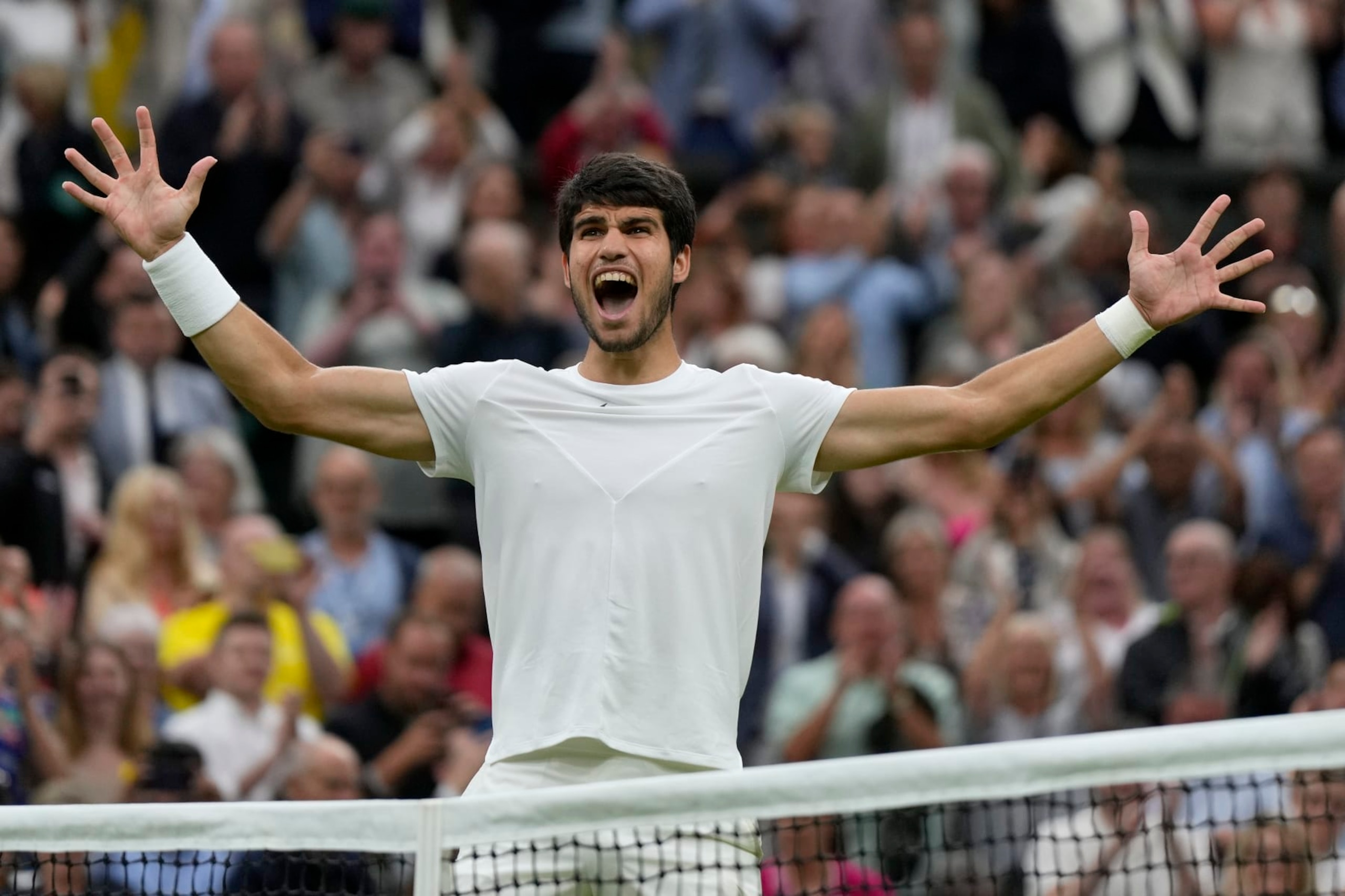 Spain's Carlos Alcaraz celebrates after beating Russia's Daniil Medvedev to win their men's singles semifinal match on day twelve of the Wimbledon tennis championships in London, Friday, July 14, 2023. (AP Photo/Alastair Grant)