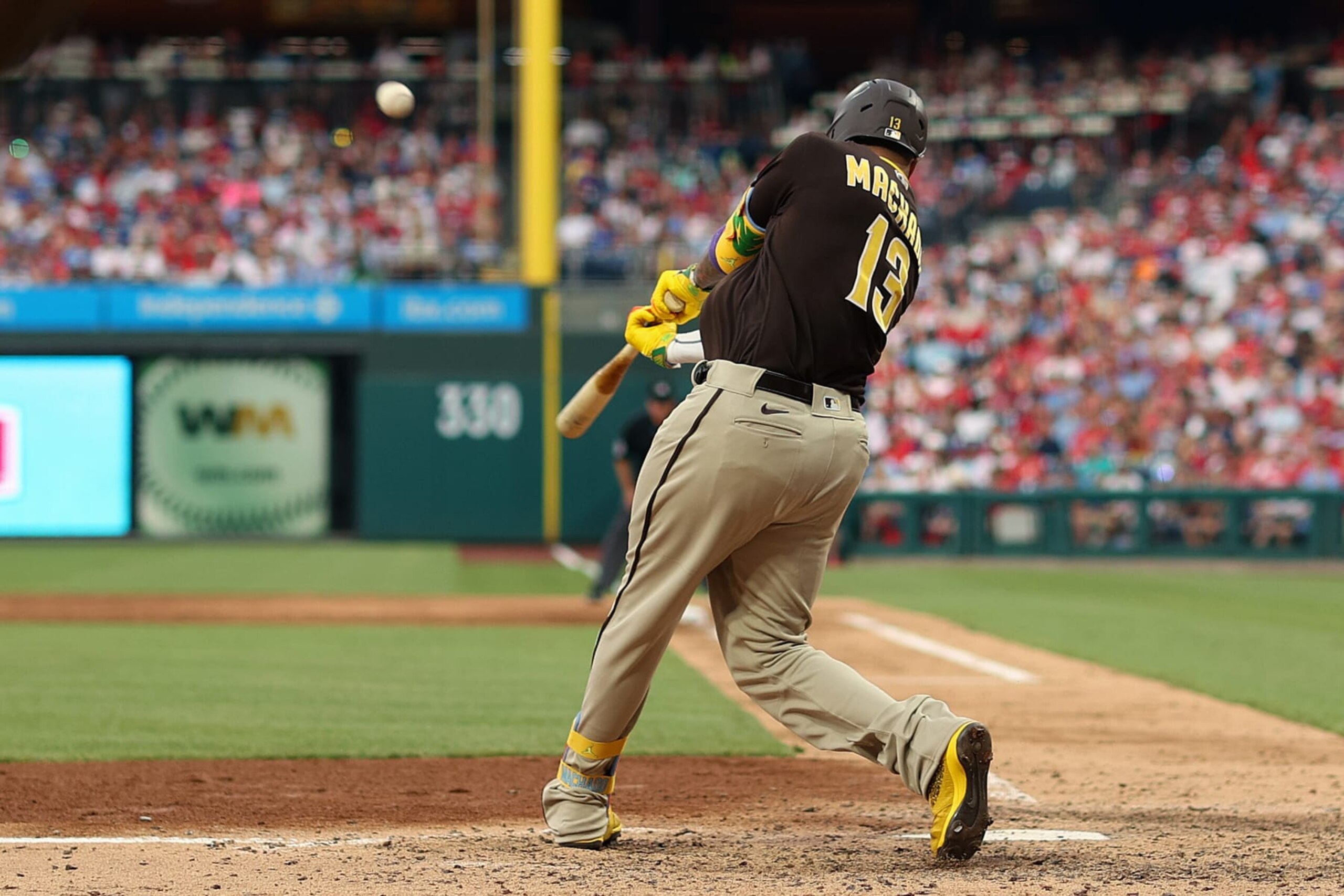 PHILADELPHIA, PENNSYLVANIA - JULY 14: Manny Machado #13 of the San Diego Padres hits a solo home run during the sixth inning against the Philadelphia Phillies at Citizens Bank Park on July 14, 2023 in Philadelphia, Pennsylvania. (Photo by Tim Nwachukwu/Getty Images)