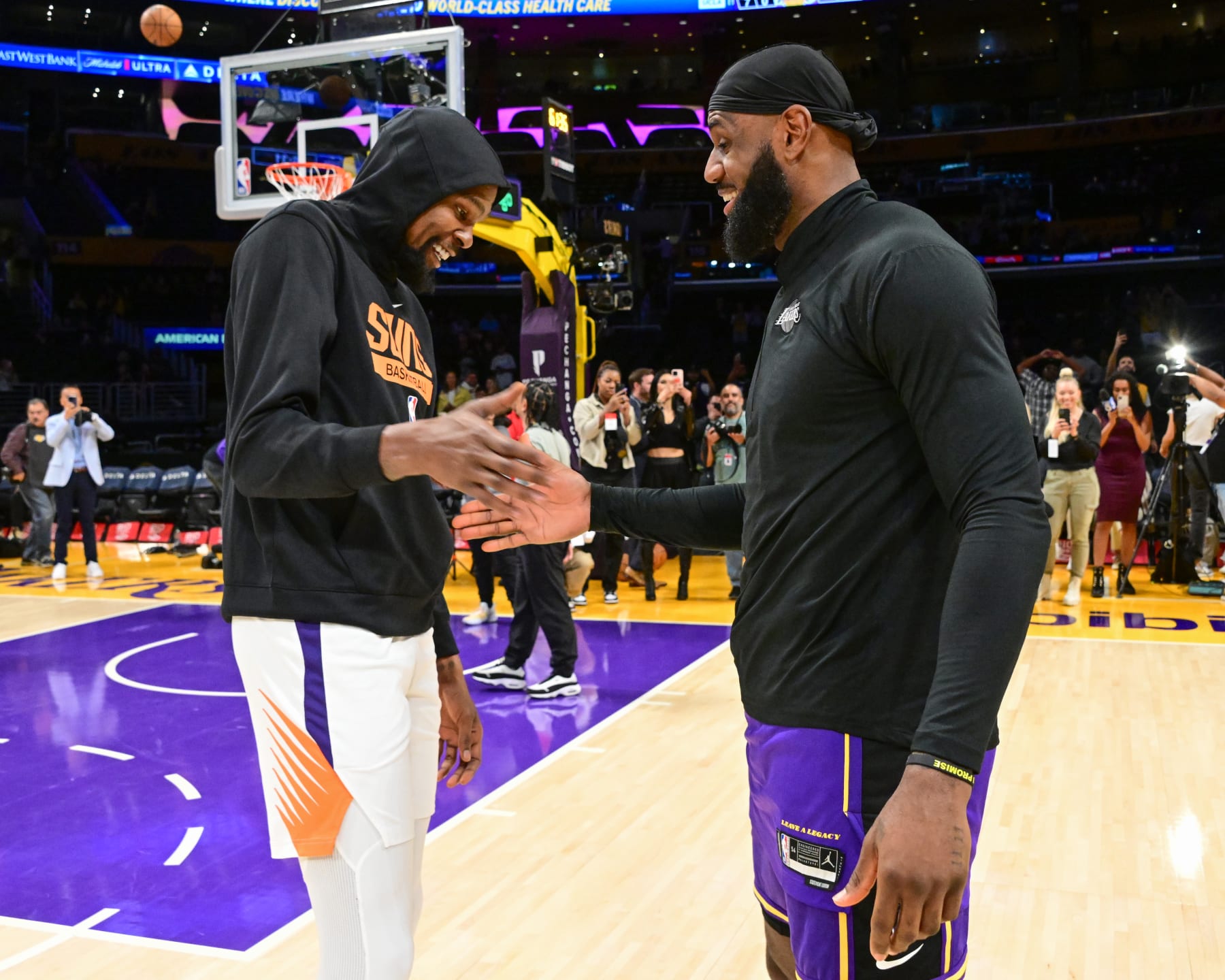 LOS ANGELES, CA - APRIL 7:  LeBron James #6 of the Los Angeles Lakers and Kevin Durant #35 of the Phoenix Suns embrace before the game on April 7, 2023 at Crypto.Com Arena in Los Angeles, California. NOTE TO USER: User expressly acknowledges and agrees that, by downloading and/or using this Photograph, user is consenting to the terms and conditions of the Getty Images License Agreement. Mandatory Copyright Notice: Copyright 2023 NBAE (Photo by Adam Pantozzi/NBAE via Getty Images)