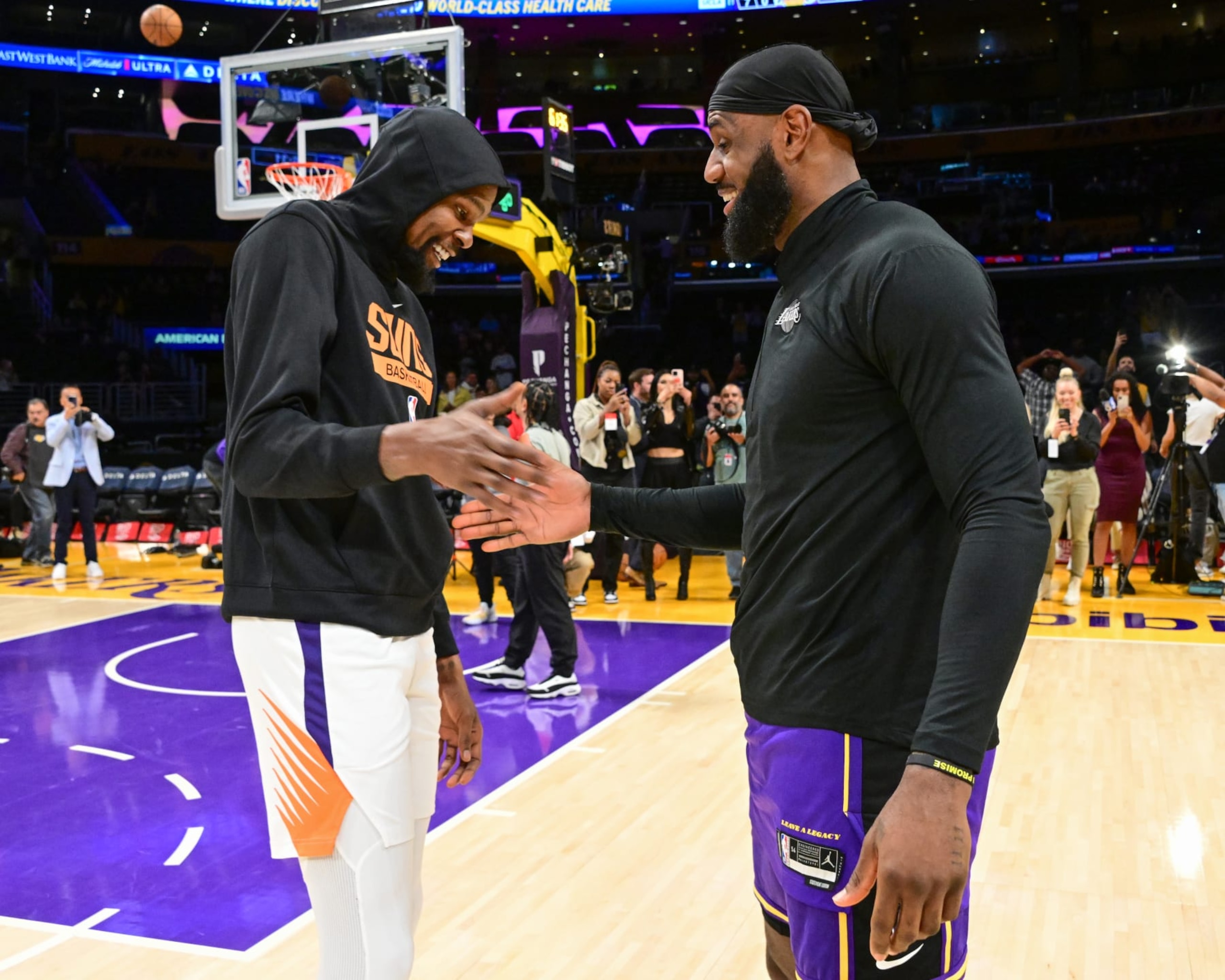 LOS ANGELES, CA - APRIL 7:  LeBron James #6 of the Los Angeles Lakers and Kevin Durant #35 of the Phoenix Suns embrace before the game on April 7, 2023 at Crypto.Com Arena in Los Angeles, California. NOTE TO USER: User expressly acknowledges and agrees that, by downloading and/or using this Photograph, user is consenting to the terms and conditions of the Getty Images License Agreement. Mandatory Copyright Notice: Copyright 2023 NBAE (Photo by Adam Pantozzi/NBAE via Getty Images)