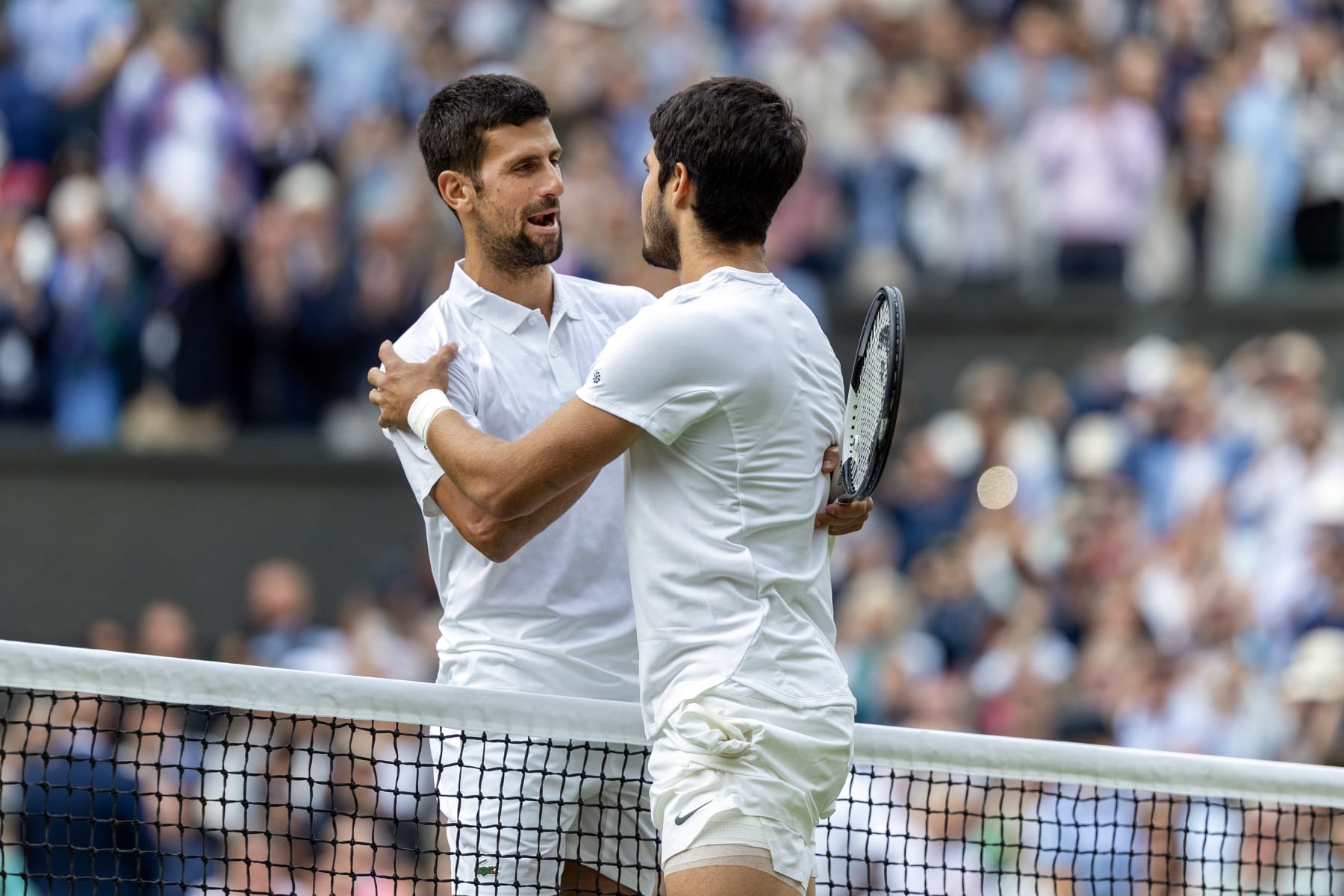 LONDON, ENGLAND - JULY 16.  Winner Carlos Alcaraz of Spain is congratulated by Novak Djokovic of Serbia at the net after their Gentlemen's Singles Final match on Centre Court during the Wimbledon Lawn Tennis Championships at the All England Lawn Tennis and Croquet Club at Wimbledon on July 16, 2023, in London, England. (Photo by Tim Clayton/Corbis via Getty Images)