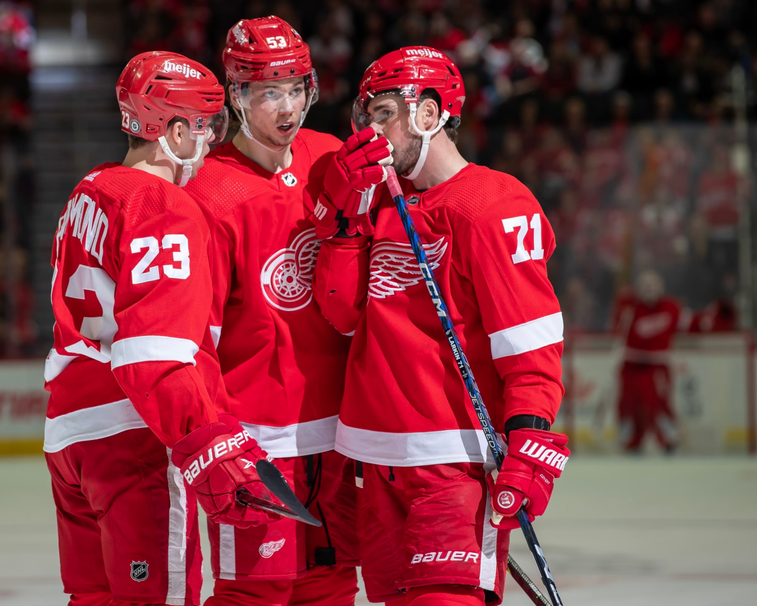 DETROIT, MI - MARCH 30: Dylan Larkin #71 of the Detroit Red Wings talks to Lucas Raymond #23 and Moritz Seider #53 before a face off during the third period of an NHL game against the Carolina Hurricanes at Little Caesars Arena on March 30, 2023 in Detroit, Michigan. Detroit defeated Carolina 3-2. (Photo by Dave Reginek/NHLI via Getty Images)