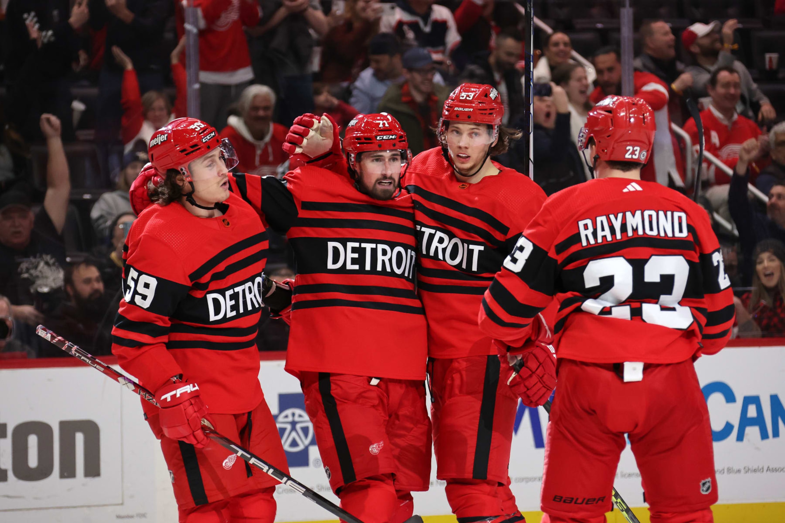 DETROIT, MICHIGAN - JANUARY 10: Dylan Larkin #71 of the Detroit Red Wings celebrates his second period goal with Tyler Bertuzzi #59, Moritz Seider #53 and Lucas Raymond #23 of the Detroit Red Wings while playing the Winnipeg Jets at Little Caesars Arena on January 10, 2023 in Detroit, Michigan. Detroit won the game 7-5. (Photo by Gregory Shamus/Getty Images)