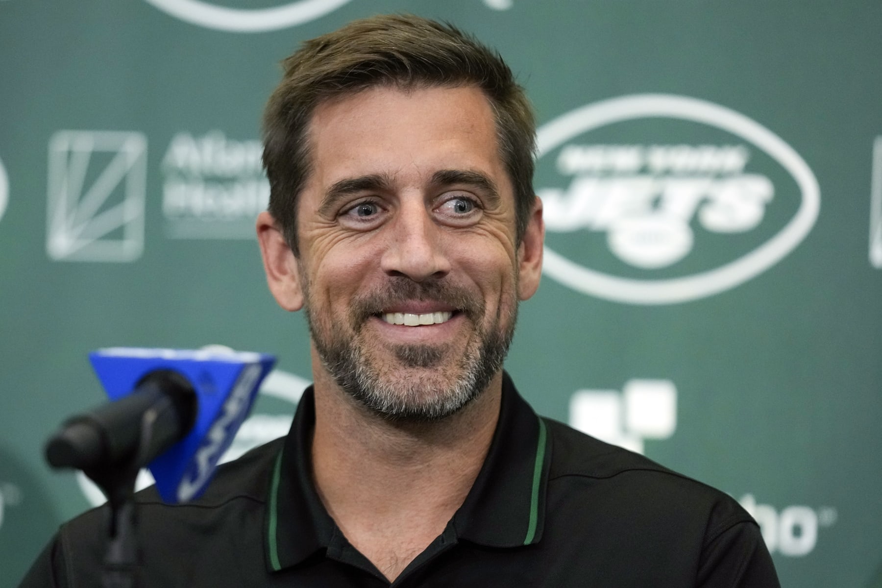 FILE - New York Jets' quarterback Aaron Rodgers smiles during an NFL football news conference at the Jets' training facility in Florham Park, N.J., Wednesday, April 26, 2023. Months after Colorado’s voters decided to join Oregon in decriminalizing psychedelic mushrooms, Denver will host a conference this week put on by a psychedelic advocacy group bringing together an unlikely cohort of speakers — including Rodgers, former Texas Gov. Rick Perry, and rapper Jaden Smith, the son of actor Will Smith. (AP Photo/Seth Wenig, File)