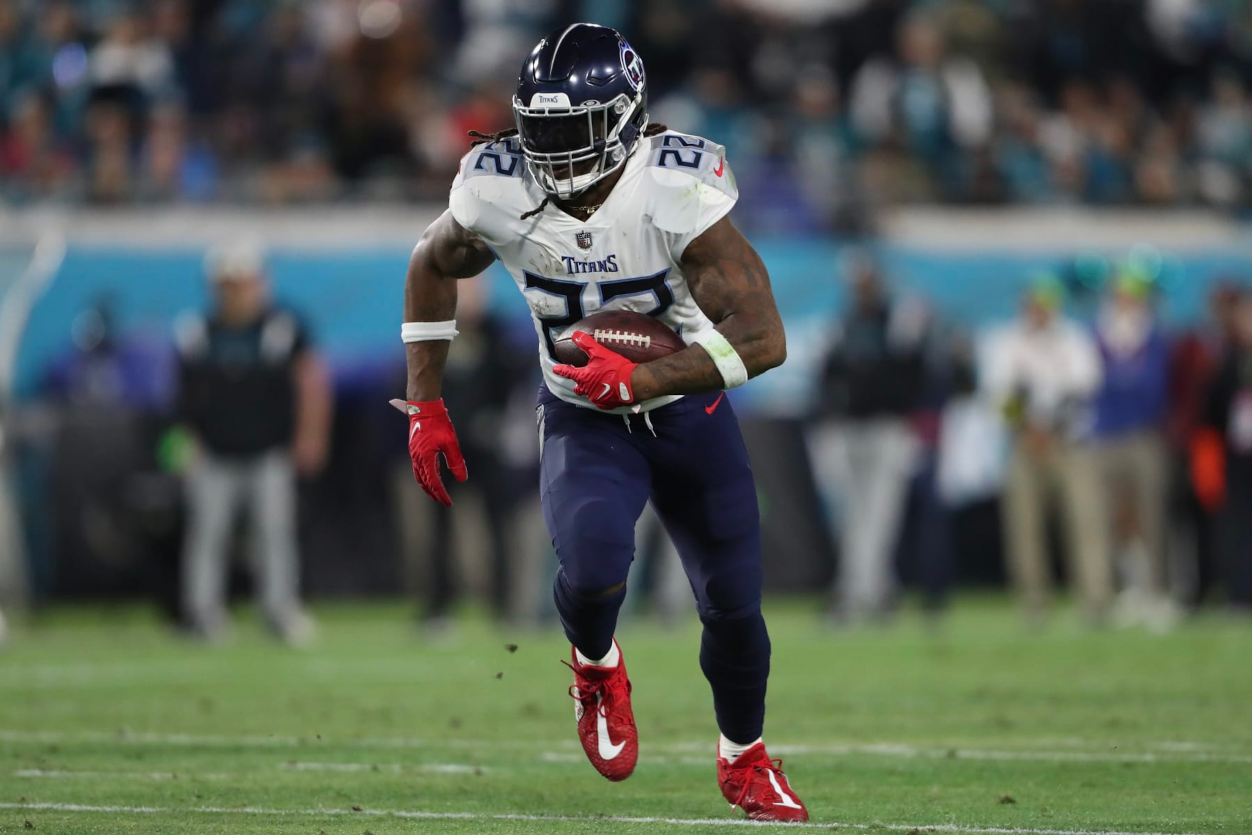 JACKSONVILLE, FLORIDA - JANUARY 07: Derrick Henry #22 of the Tennessee Titans carries the ball during the first half against the Jacksonville Jaguars at TIAA Bank Field on January 07, 2023 in Jacksonville, Florida. (Photo by Courtney Culbreath/Getty Images)