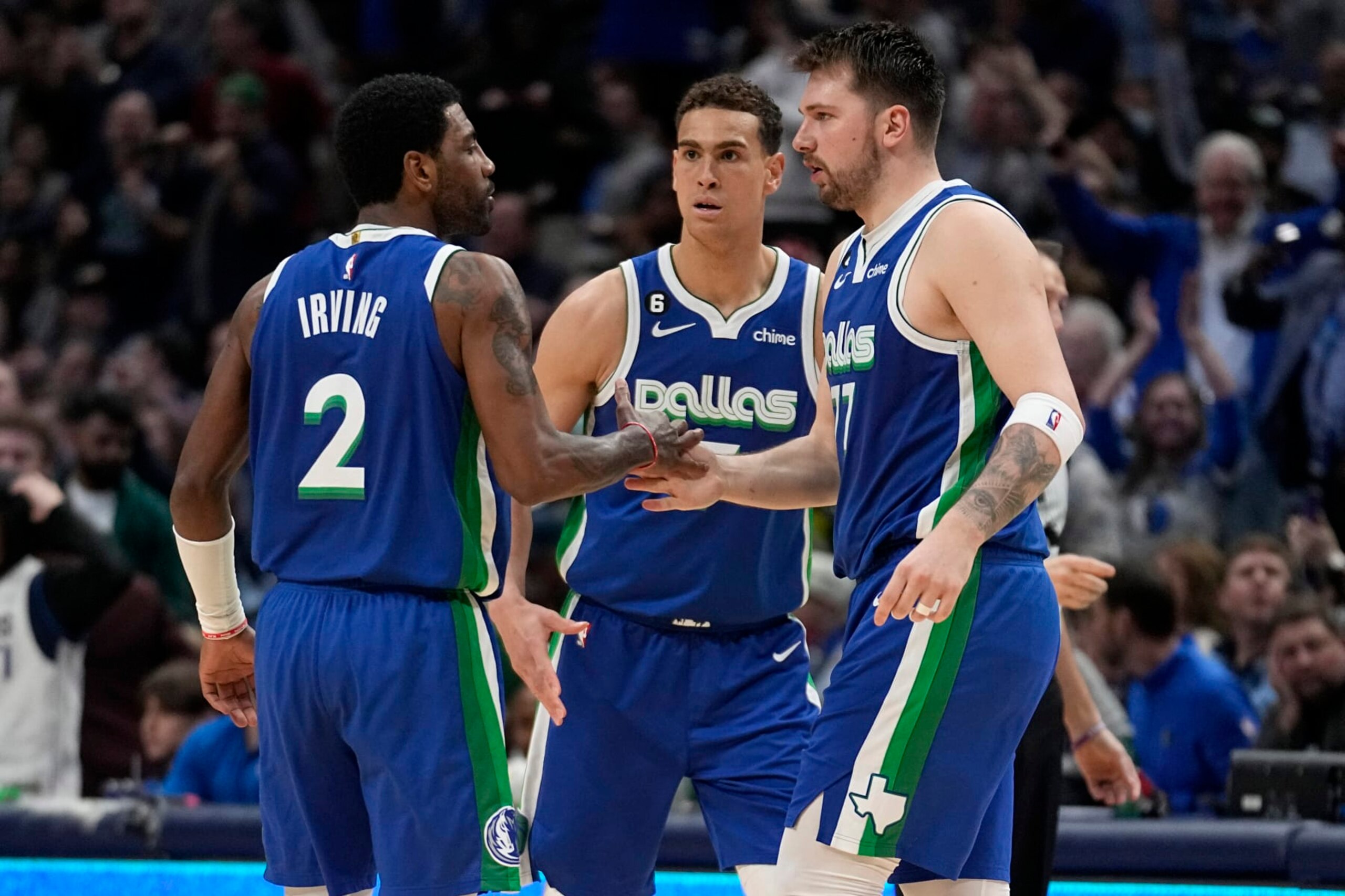Dallas Mavericks' Kyrie Irving (2), Dwight Powell, center, and Luka Doncic, right, celebrate after Irving sank a three-point shot in the second half of an NBA basketball game against the Philadelphia 76ers, Thursday, March 2, 2023, in Dallas. (AP Photo/Tony Gutierrez) Dallas Mavericks' Kyrie Irving (2), Dwight Powell, center, and Luka Doncic, right, celebrate after Irving sank a three-point shot in the second half of an NBA basketball game against the Philadelphia 76ers, Thursday, March 2, 2023, in Dallas. (AP Photo/Tony Gutierrez)