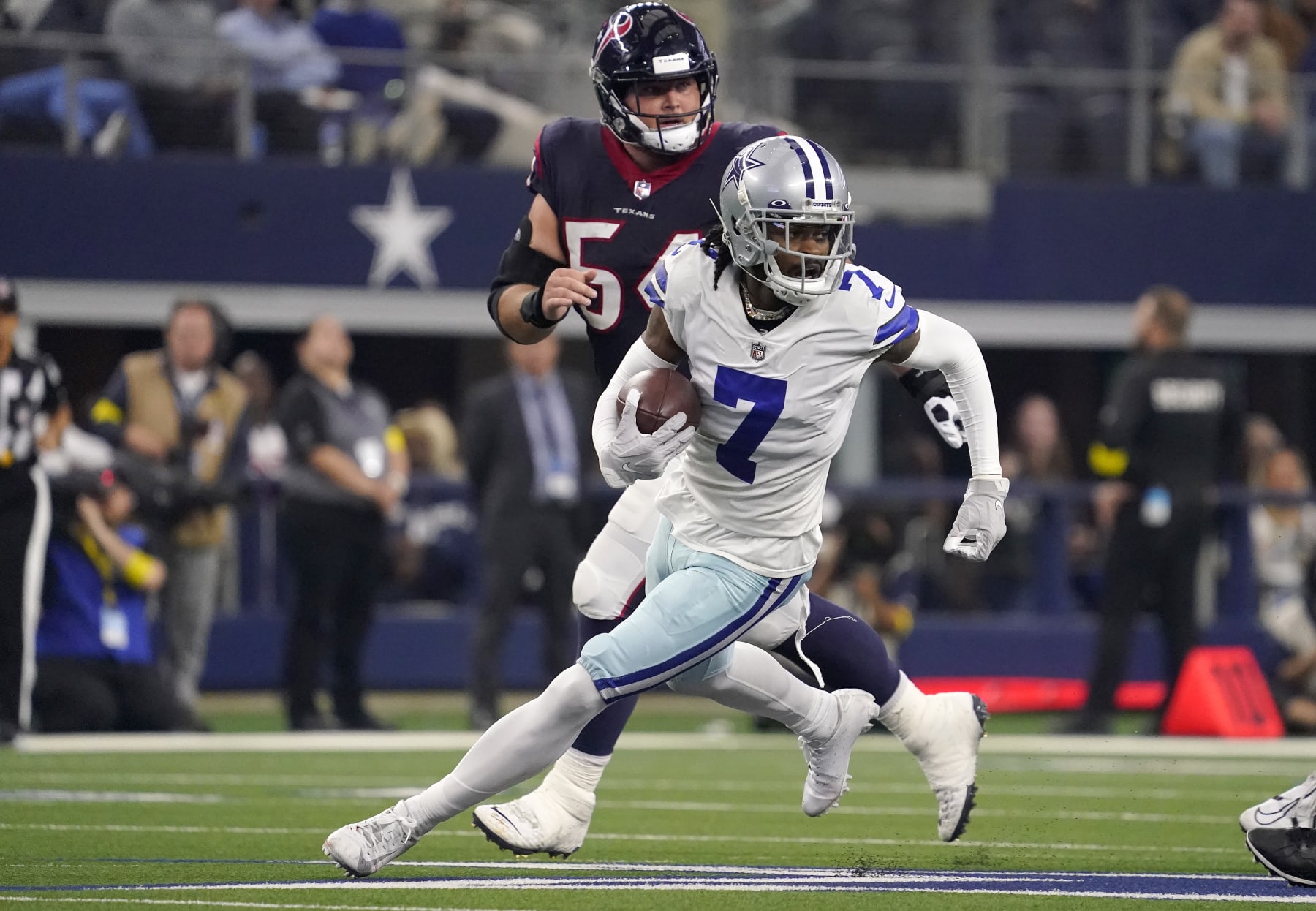 ARLINGTON, TEXAS - DECEMBER 11: Trevon Diggs #7 of the Dallas Cowboys runs with the ball  in the second half of a game against the Houston Texans at AT&T Stadium on December 11, 2022 in Arlington, Texas. (Photo by Sam Hodde/Getty Images)