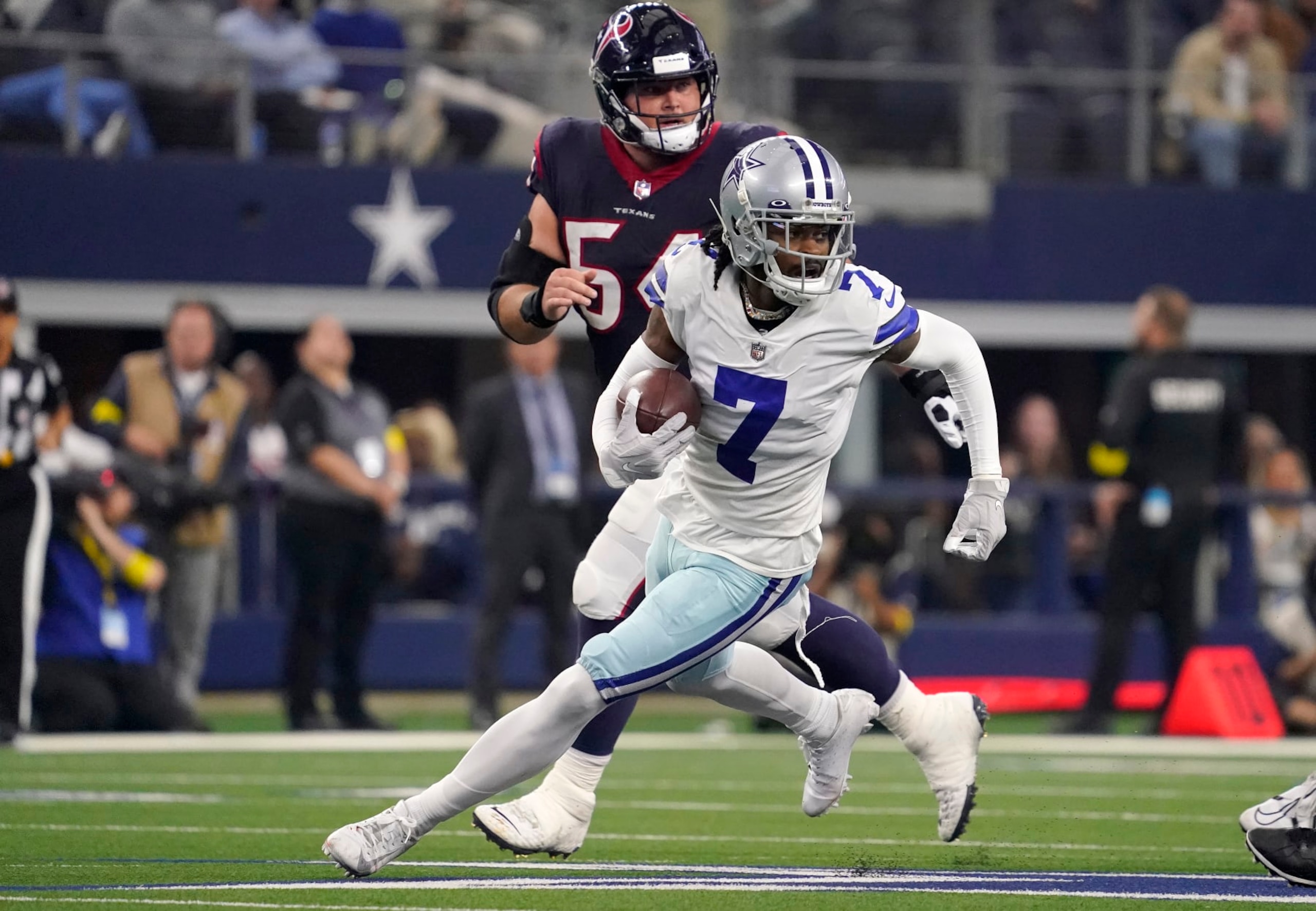 ARLINGTON, TEXAS - DECEMBER 11: Trevon Diggs #7 of the Dallas Cowboys runs with the ball  in the second half of a game against the Houston Texans at AT&T Stadium on December 11, 2022 in Arlington, Texas. (Photo by Sam Hodde/Getty Images)