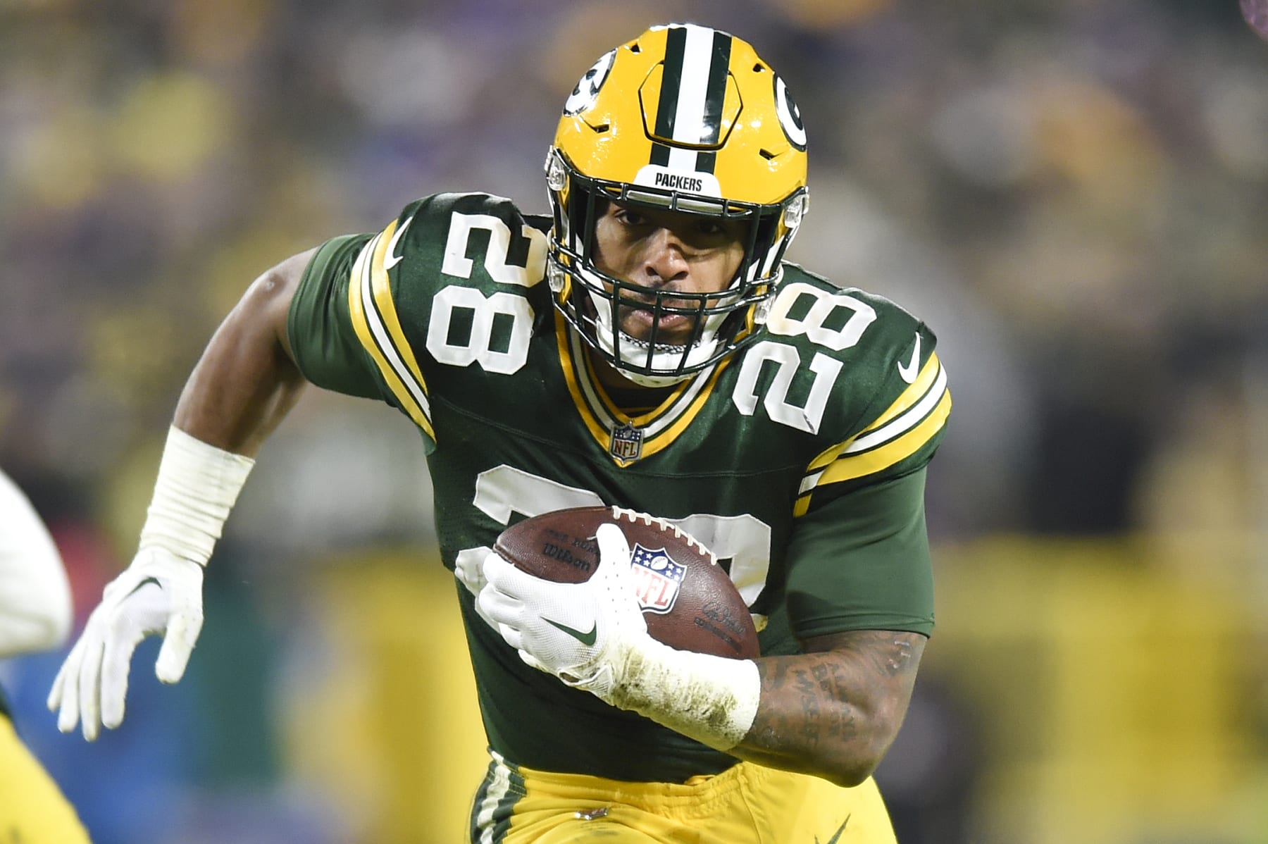 GREEN BAY, WISCONSIN - JANUARY 01: AJ Dillon #28 of the Green Bay Packers runs the ball against the Minnesota Vikings during the third quarter at Lambeau Field on January 01, 2023 in Green Bay, Wisconsin. (Photo by Kayla Wolf/Getty Images)