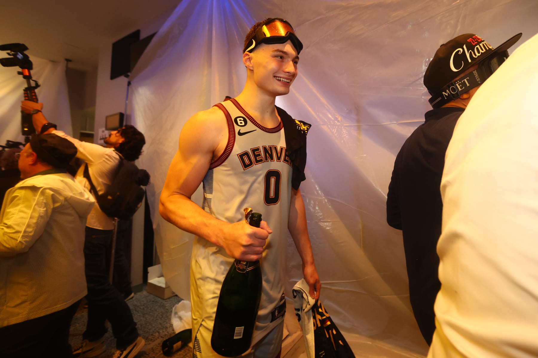 DENVER, CO - JUNE 12: Christian Braun #0 of the Denver Nuggets celebrates in the locker room after winning Game Five of the 2023 NBA Finals against the Miami Heat on June 12, 2023 at Ball Arena in Denver, Colorado. NOTE TO USER: User expressly acknowledges and agrees that, by downloading and or using this Photograph, user is consenting to the terms and conditions of the Getty Images License Agreement. Mandatory Copyright Notice: Copyright 2023 NBAE (Photo by Nathaniel S. Butler/NBAE via Getty Images)