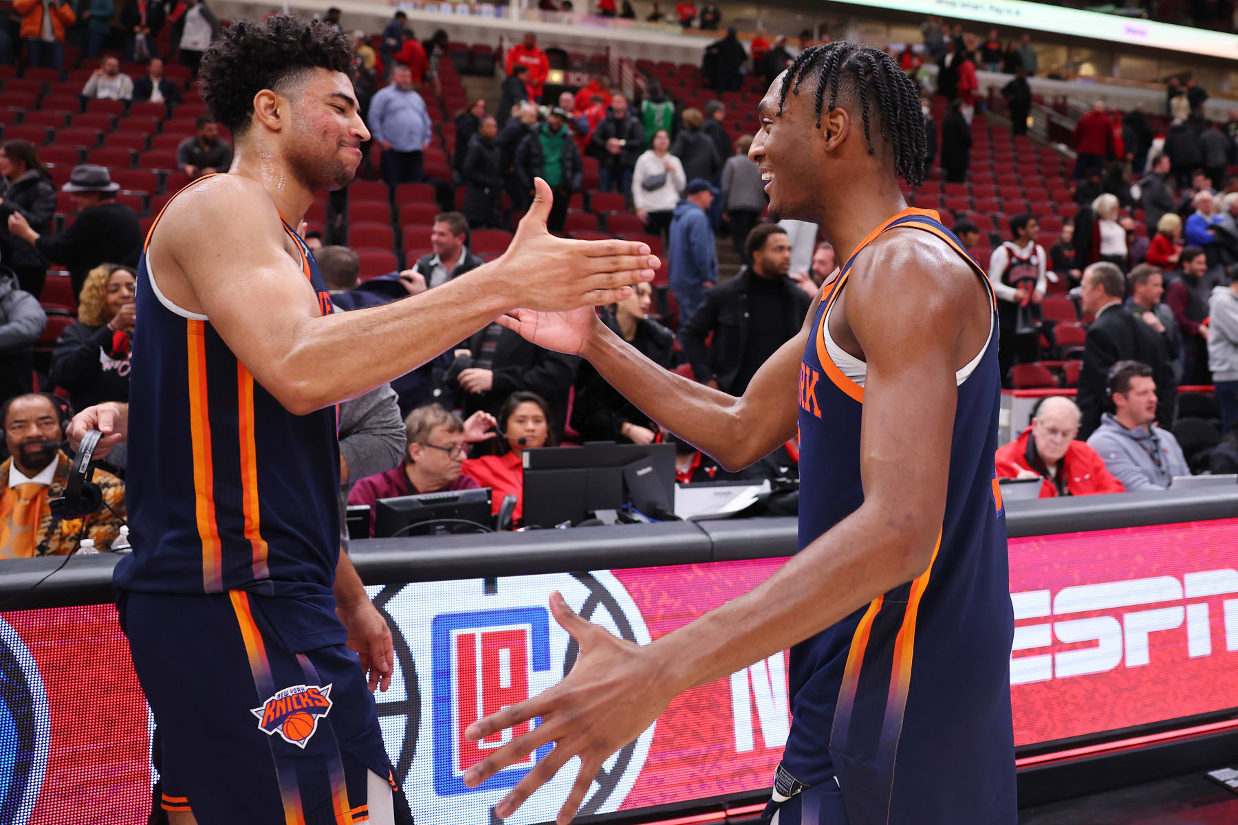 CHICAGO, ILLINOIS - DECEMBER 14: Quentin Grimes #6 and Immanuel Quickley #5 of the New York Knicks celebrate after defeating the Chicago Bulls at United Center on December 14, 2022 in Chicago, Illinois. NOTE TO USER: User expressly acknowledges and agrees that, by downloading and or using this photograph, User is consenting to the terms and conditions of the Getty Images License Agreement.  (Photo by Michael Reaves/Getty Images)