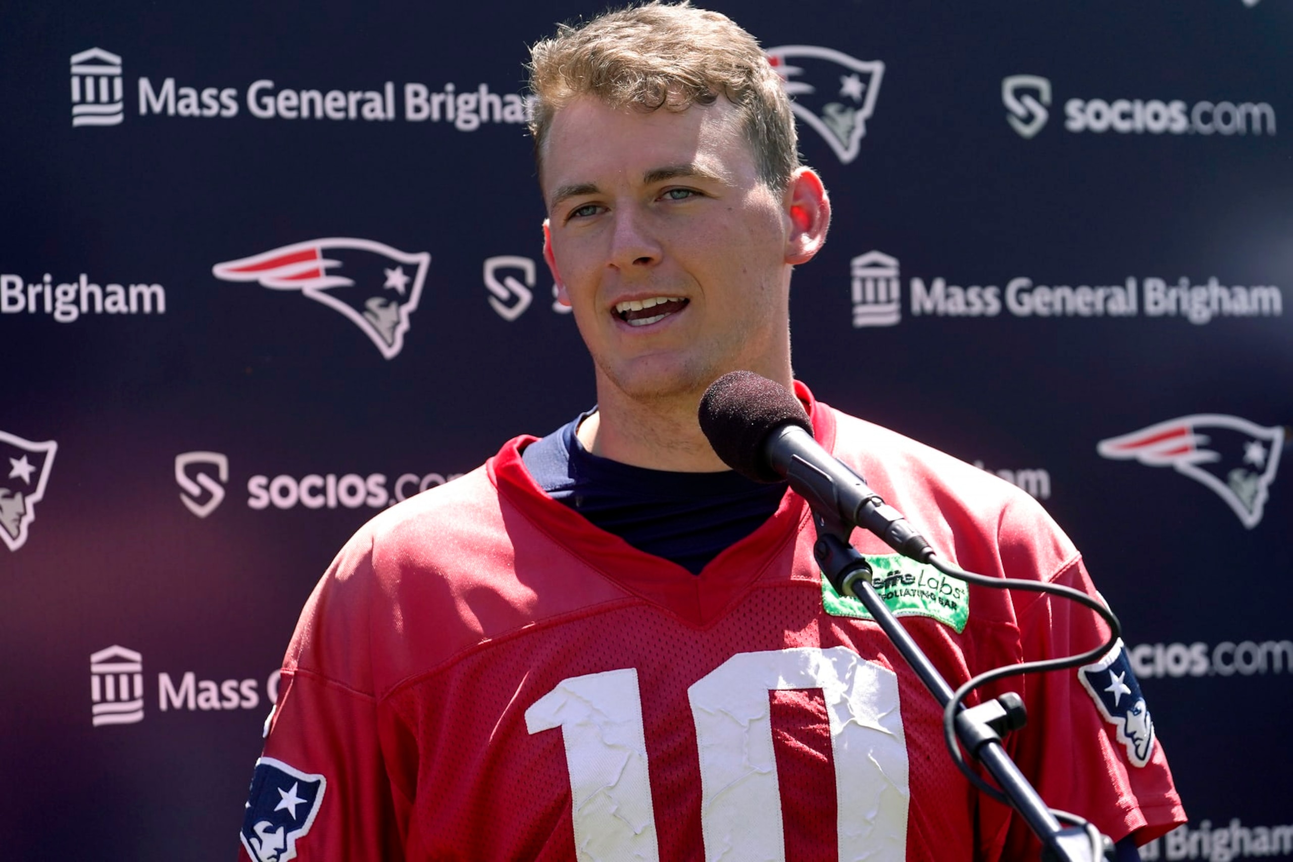 New England Patriots quarterback Mac Jones speaks with reporters following an NFL football offseason workout, Wednesday, May 31, 2023, in Foxborough, Mass. (AP Photo/Steven Senne)