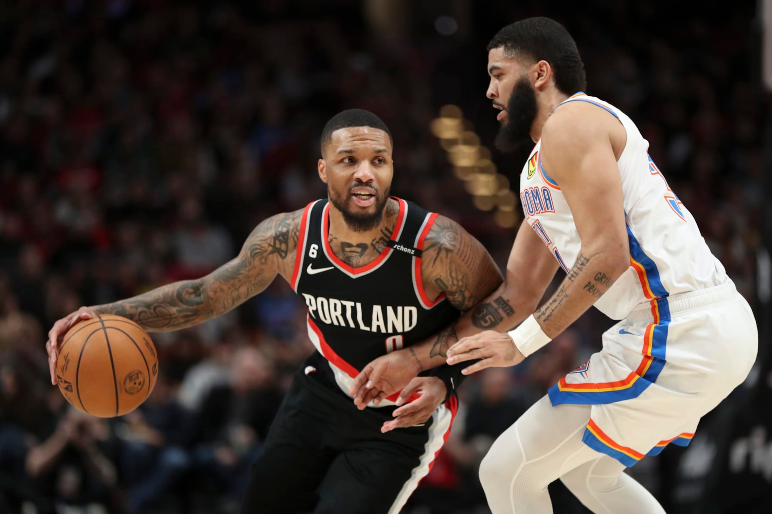 PORTLAND, OREGON - FEBRUARY 10: Damian Lillard #0 of the Portland Trail Blazers drives past Kenrich Williams #34 of the Oklahoma City Thunder during the first quarter at Moda Center on February 10, 2023 in Portland, Oregon. NOTE TO USER: User expressly acknowledges and agrees that, by downloading and or using this photograph, user is consenting to the terms and conditions of the Getty Images License Agreement. (Photo by Amanda Loman/Getty Images) (Photo by Amanda Loman/Getty Images) PORTLAND, OREGON - FEBRUARY 10: Damian Lillard #0 of the Portland Trail Blazers drives past Kenrich Williams #34 of the Oklahoma City Thunder during the first quarter at Moda Center on February 10, 2023 in Portland, Oregon. NOTE TO USER: User expressly acknowledges and agrees that, by downloading and or using this photograph, user is consenting to the terms and conditions of the Getty Images License Agreement. (Photo by Amanda Loman/Getty Images) (Photo by Amanda Loman/Getty Images)