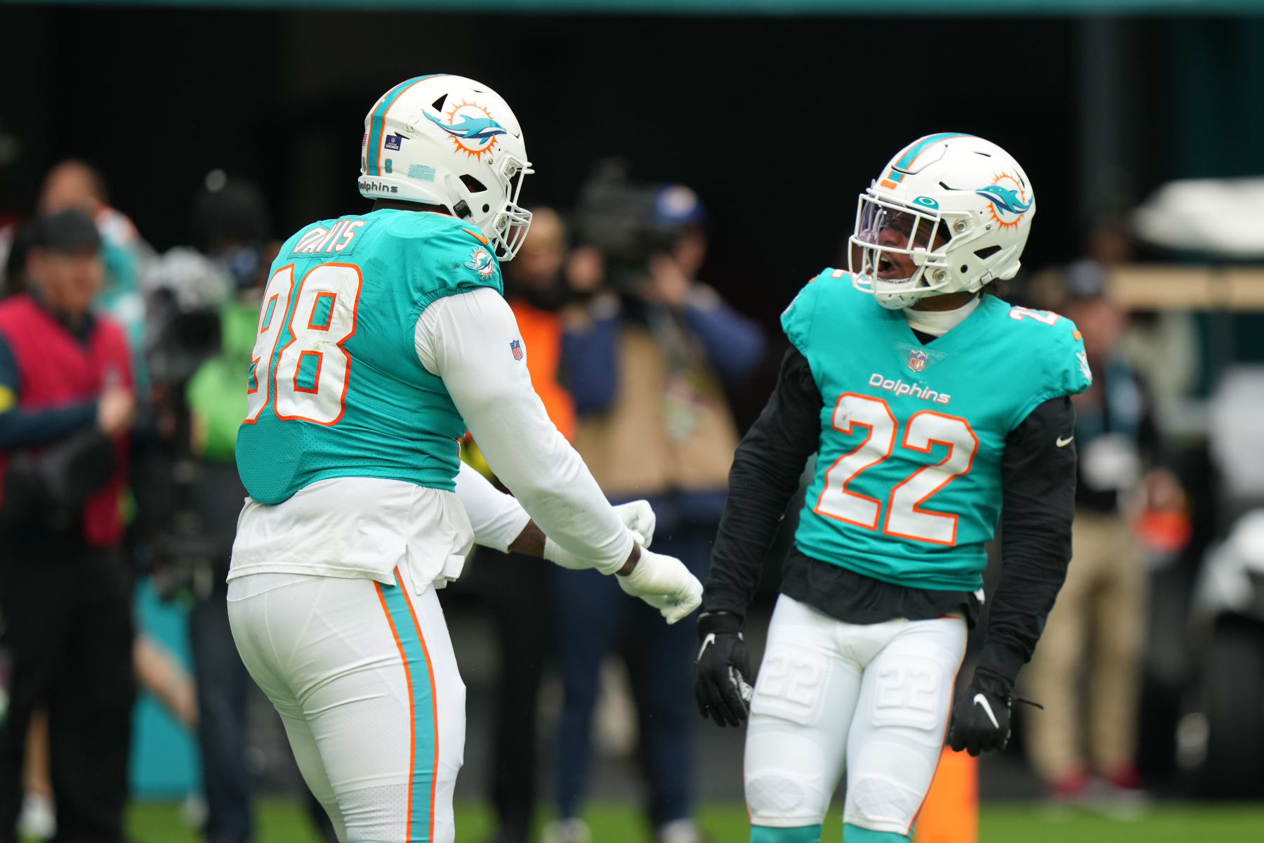 MIAMI GARDENS, FL - DECEMBER 25: Miami Dolphins safety Elijah Campbell (22) and Miami Dolphins defensive tackle Raekwon Davis (98) celebrate a defensive stop on  fourth down during the game between the Green Bay Packers and the Miami Dolphins on Sunday, December 25, 2022 at Hard Rock Stadium, Miami Gardens, Fla. (Photo by Peter Joneleit/Icon Sportswire via Getty Images)
