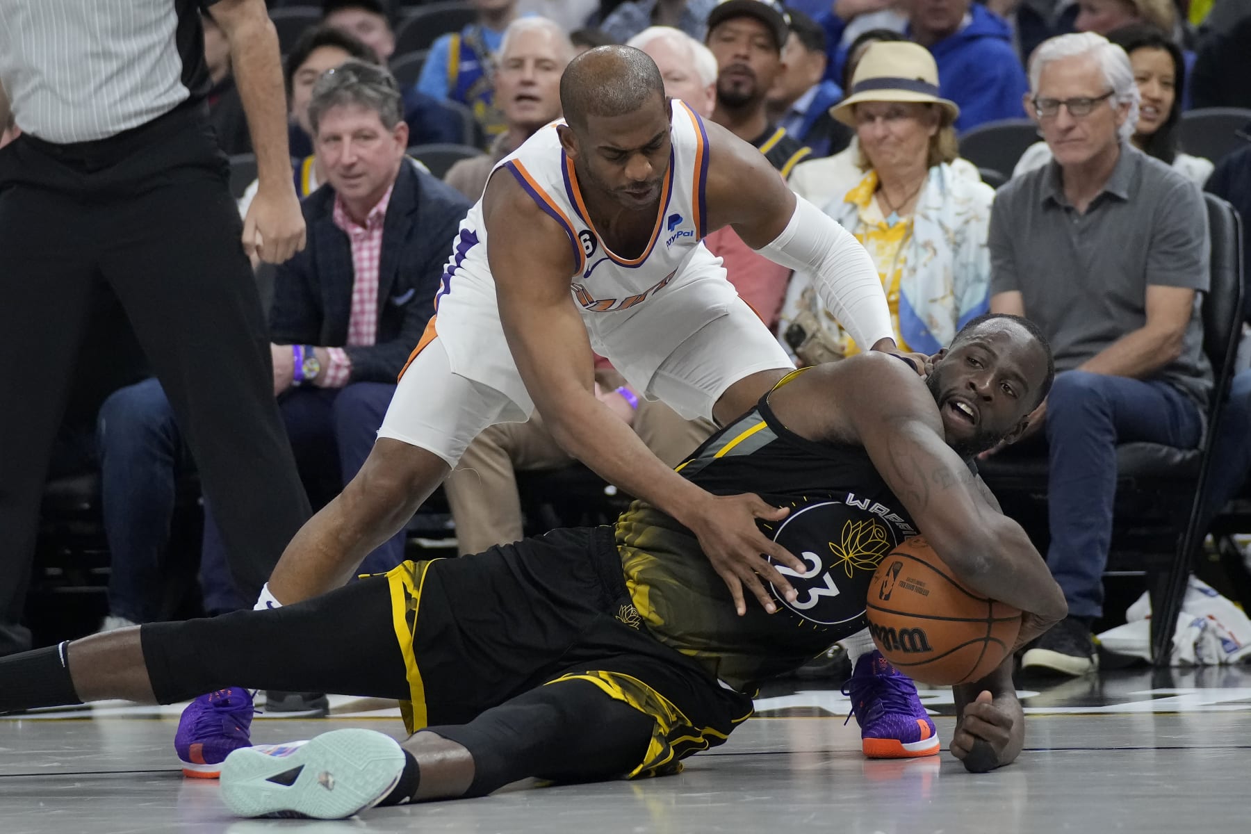 Phoenix Suns guard Chris Paul, top, reaches for the ball over Golden State Warriors forward Draymond Green during an NBA basketball game in San Francisco, Monday, March 13, 2023. (AP Photo/Jeff Chiu)